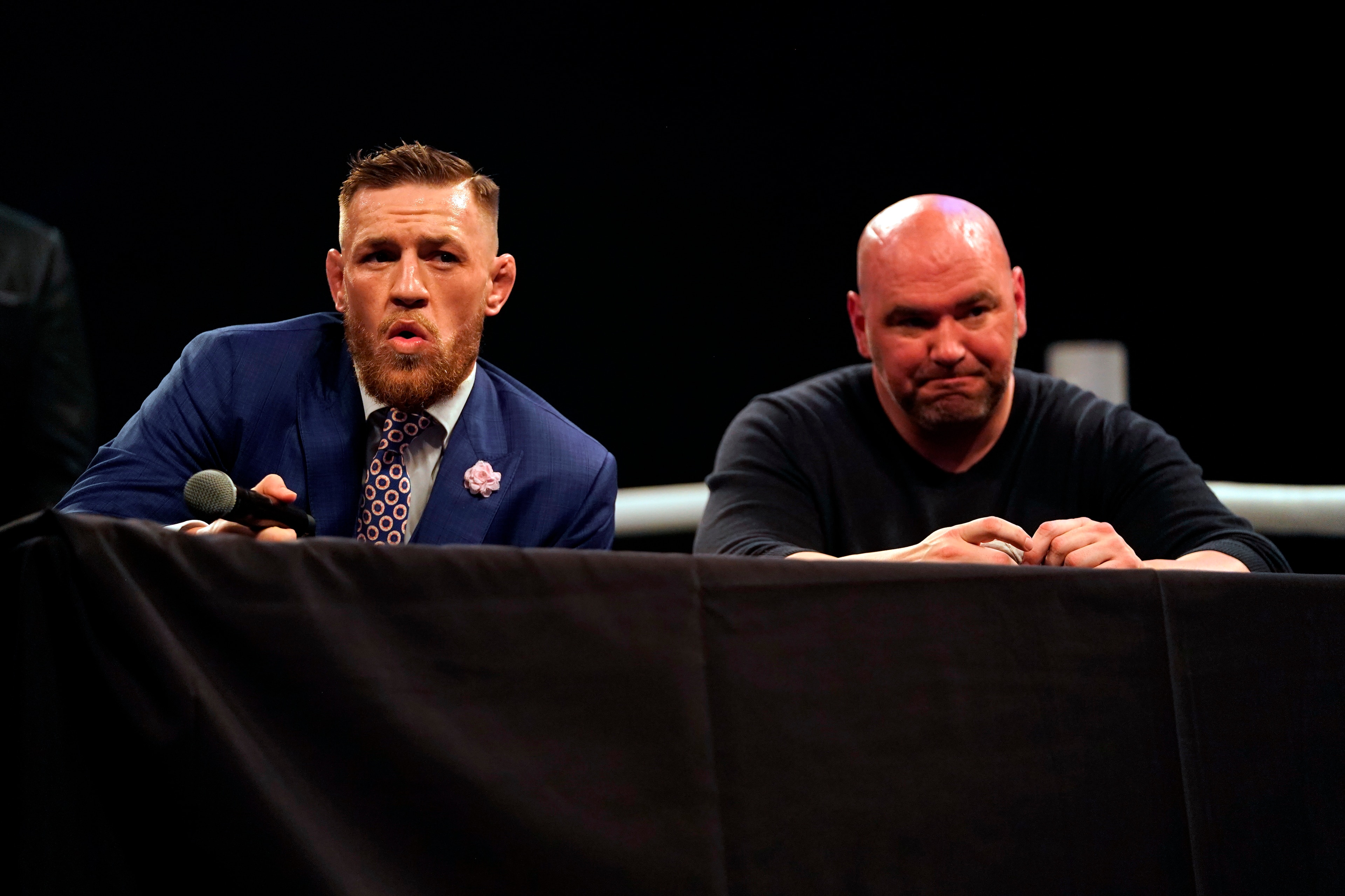 LONDON, ENGLAND - JULY 14:  (L-R) Conor McGregor interacts with the media as UFC President Dana White listens on stage during the Floyd Mayweather Jr. v Conor McGregor World Press Tour event at SSE Arena on July 14, 2017 in London, England. (Photo by Jeff