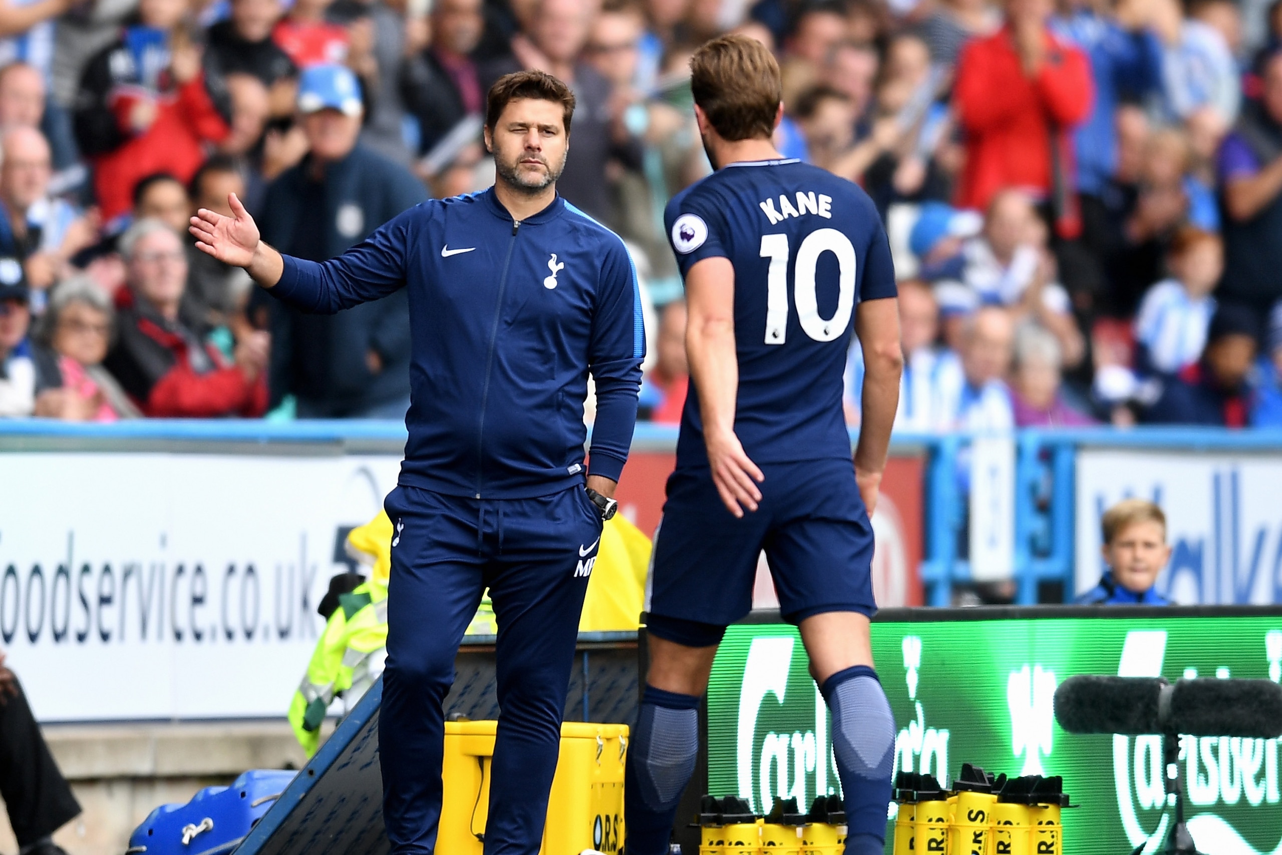 HUDDERSFIELD, ENGLAND - SEPTEMBER 30:  Harry Kane of Tottenham Hotspur and Mauricio Pochettino, Manager of Tottenham Hotspur embrace after he is subbed during the Premier League match between Huddersfield Town and Tottenham Hotspur at John Smith's Stadium