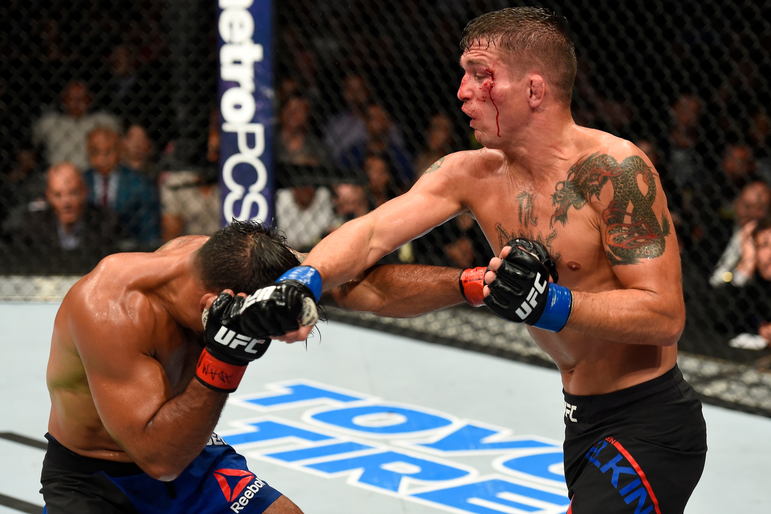 UNIONDALE, NY - JULY 22:  (R-L) Darren Elkins punches Dennis Bermudez in their featherweight bout during the UFC Fight Night event inside the Nassau Veterans Memorial Coliseum on July 22, 2017 in Uniondale, New York. (Photo by Josh Hedges/Zuffa LLC/Zuffa 