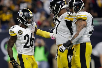 HOUSTON, TX - DECEMBER 25: Le'Veon Bell #26 of the Pittsburgh Steelers celebrates with Marcus Gilbert #77 and Maurice Pouncey #53 after a rushing touchdown in the second half against the Houston Texans at NRG Stadium on December 25, 2017 in Houston, Texas