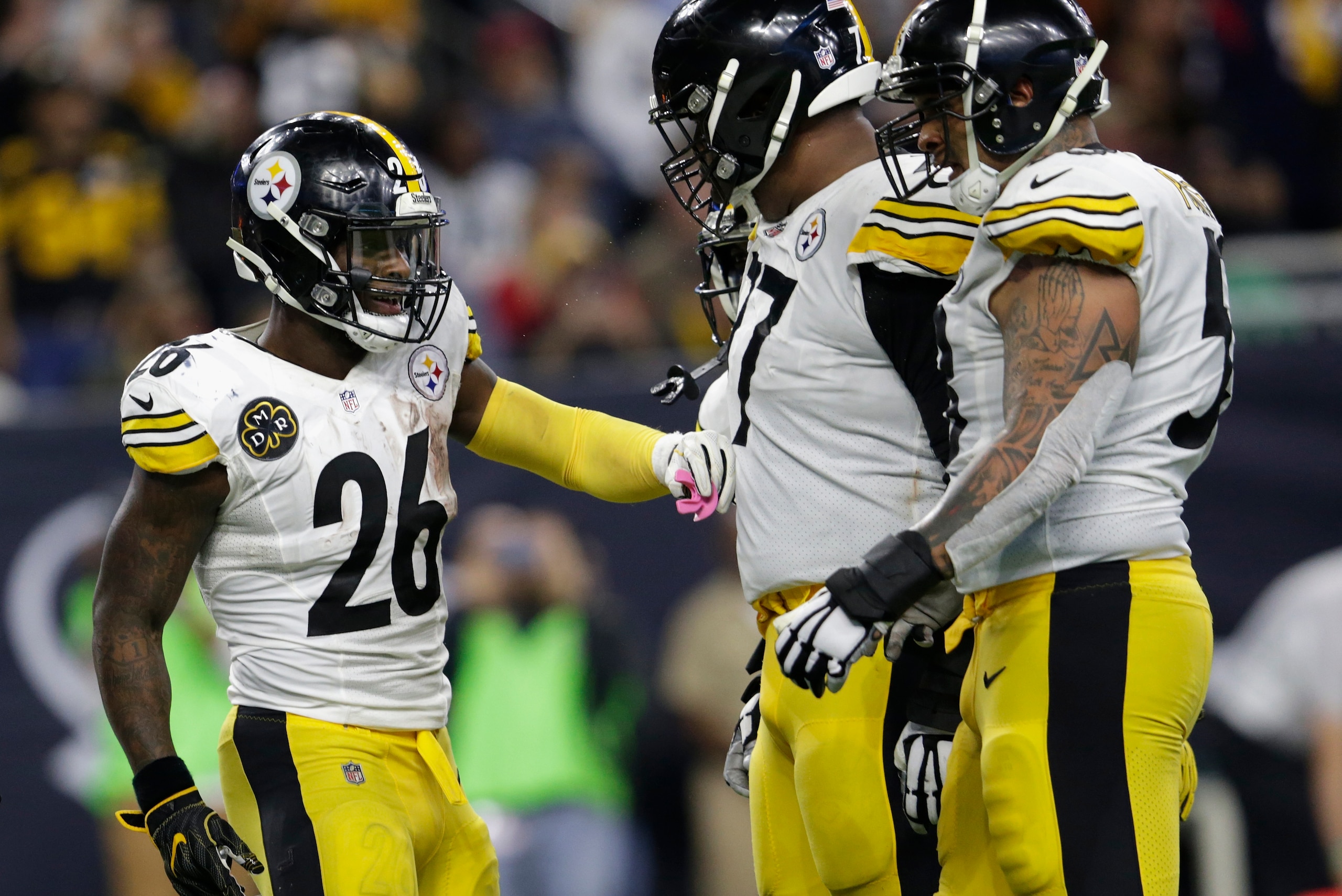 HOUSTON, TX - DECEMBER 25: Le'Veon Bell #26 of the Pittsburgh Steelers celebrates with Marcus Gilbert #77 and Maurice Pouncey #53 after a rushing touchdown in the second half against the Houston Texans at NRG Stadium on December 25, 2017 in Houston, Texas