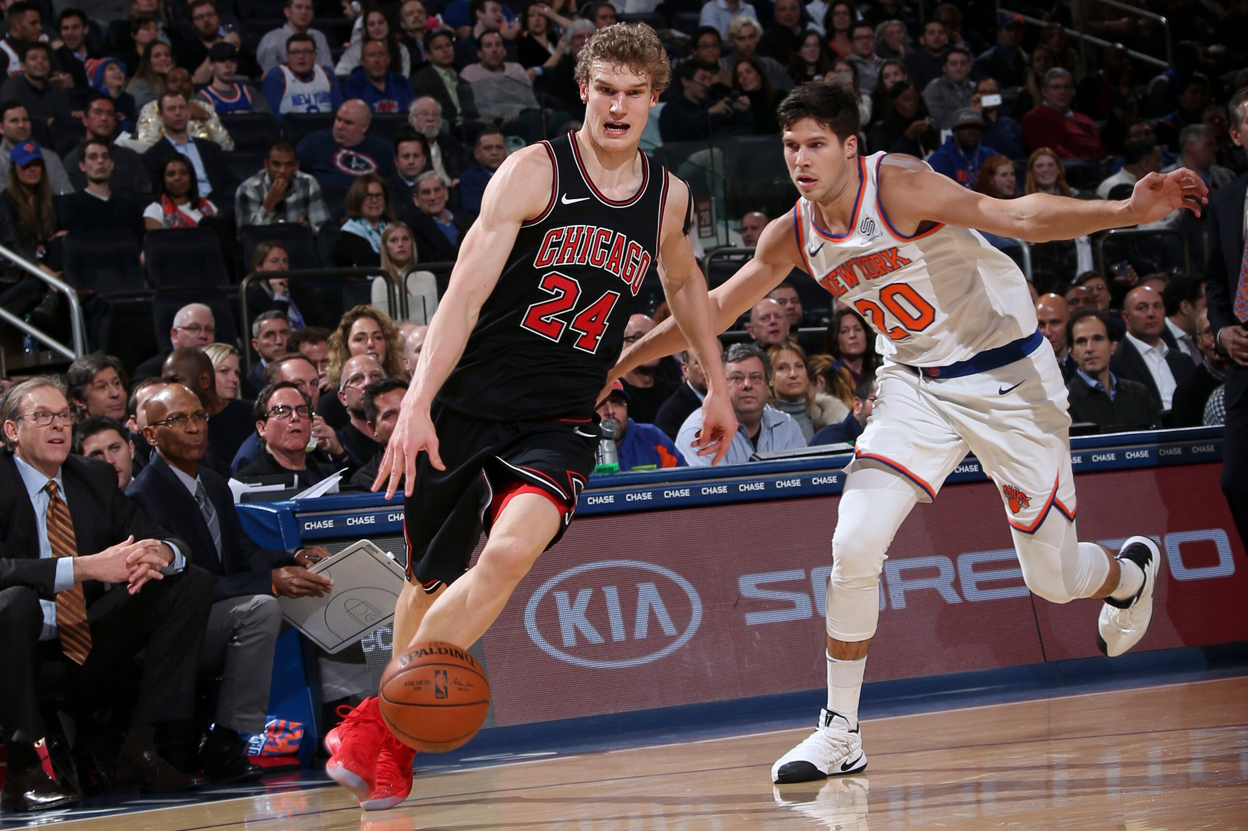 NEW YORK, NY - JANUARY 10: Lauri Markkanen #24 of the Chicago Bulls handles the ball against Doug McDermott #20 of the New York Knicks on January 10, 2018 at Madison Square Garden in New York City, New York. NOTE TO USER: User expressly acknowledges and a