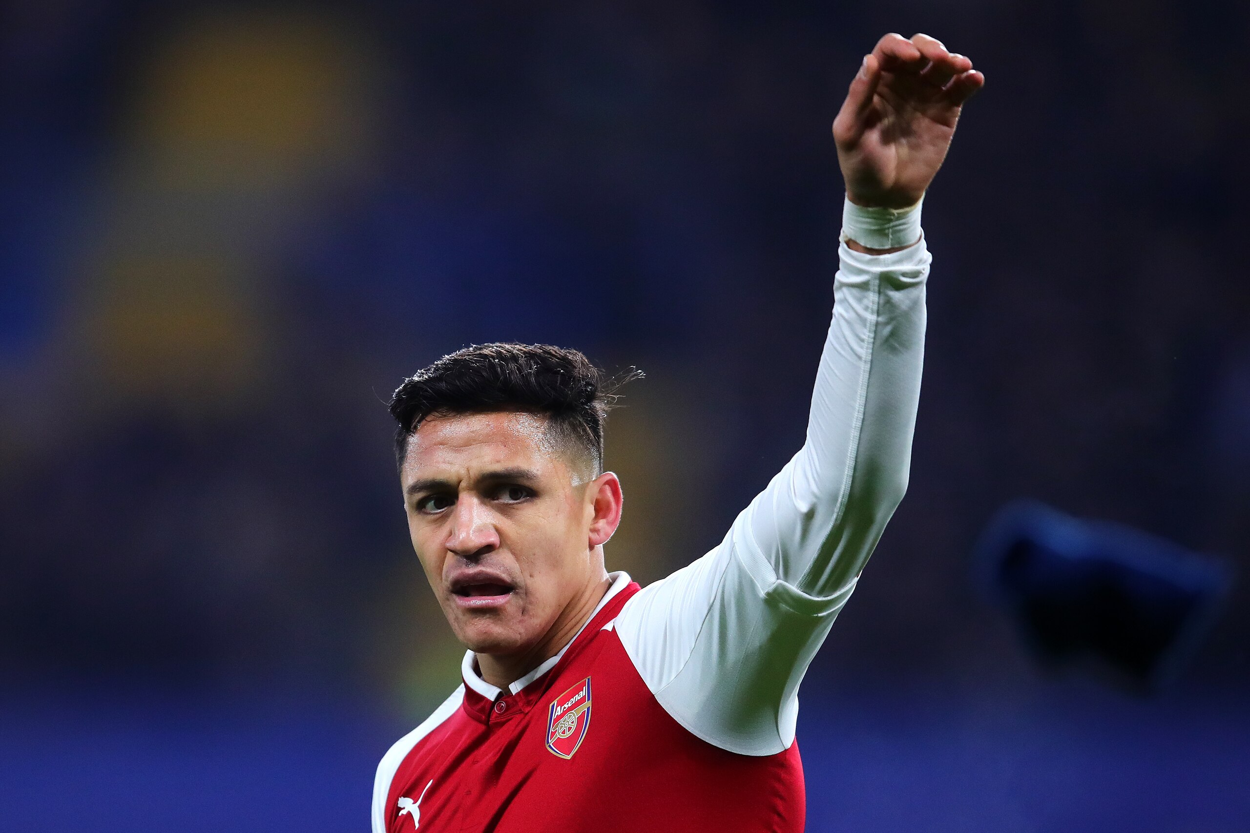 LONDON, ENGLAND - JANUARY 10: Alexis Sanchez of Arsenal discards his glove during the Carabao Cup Semi-Final first leg match between Chelsea and Arsenal at Stamford Bridge on January 10, 2018 in London, England. (Photo by Chris Brunskill Ltd/Getty Images)