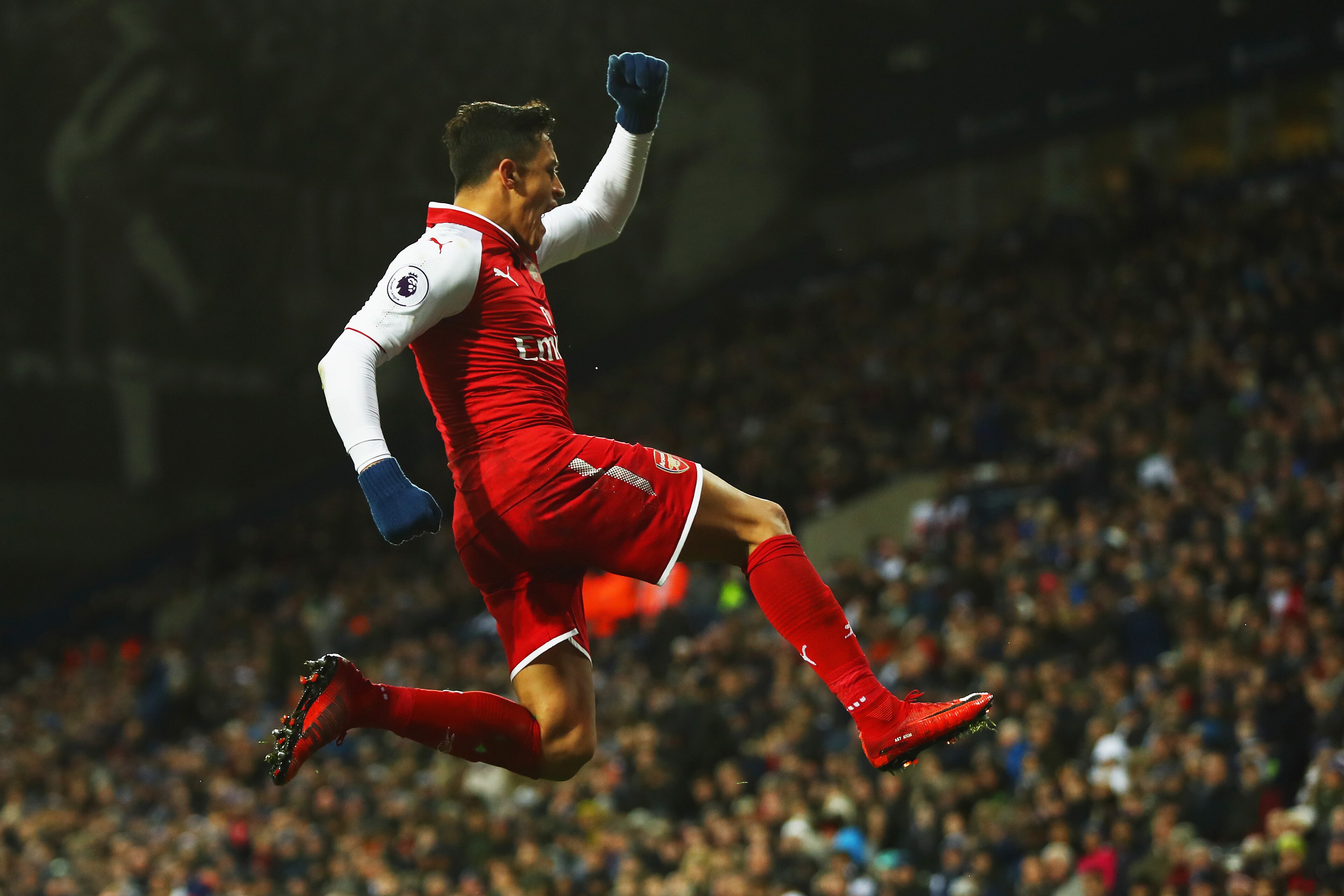WEST BROMWICH, ENGLAND - DECEMBER 31:  Alexis Sanchez of Arsenal celebrates as his free kick deflects off James McClean of West Bromwich Albion for their first goal during the Premier League match between West Bromwich Albion and Arsenal at The Hawthorns 