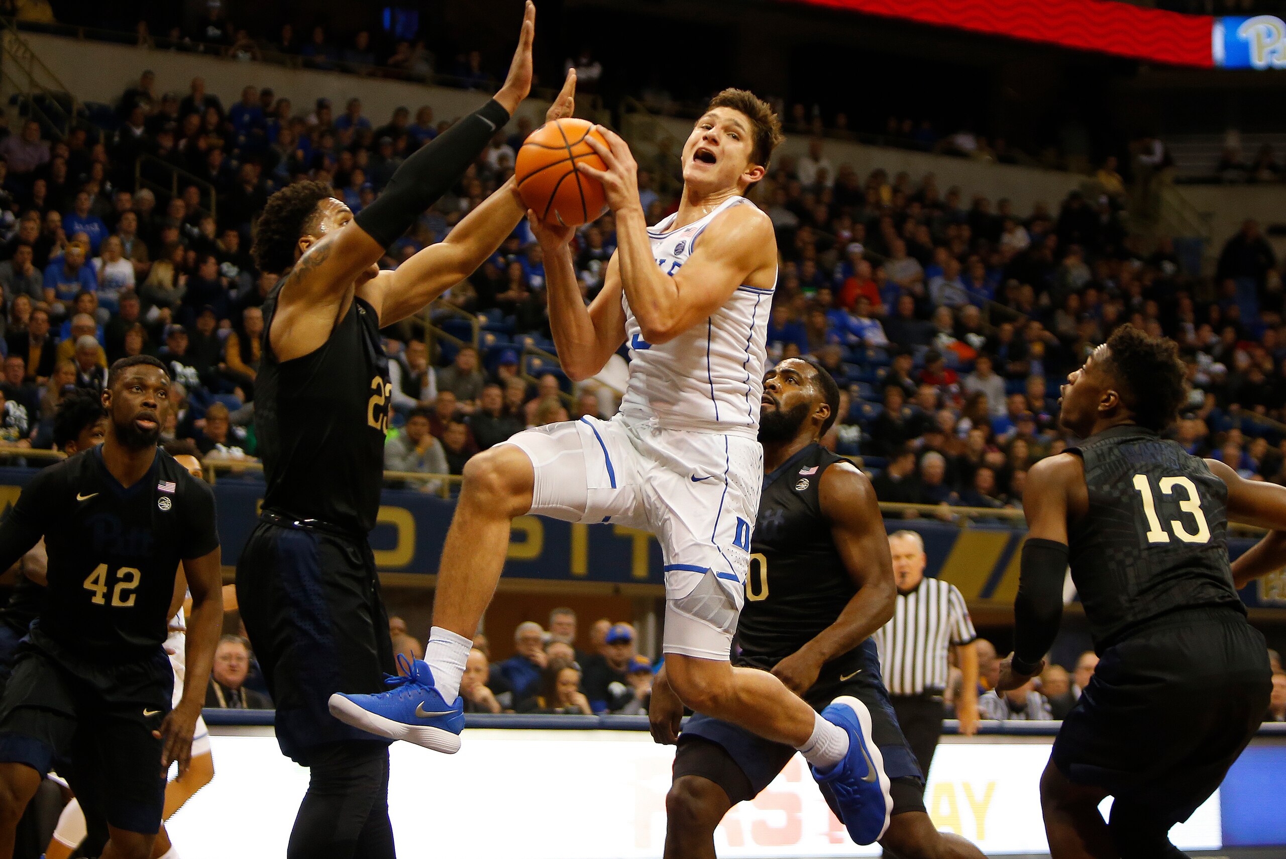 PITTSBURGH, PA - JANUARY 10:  Grayson Allen #3 of the Duke Blue Devils drives the lane against Shamiel Stevenson #23 of the Pittsburgh Panthers at Petersen Events Center on January 10, 2018 in Pittsburgh, Pennsylvania.  (Photo by Justin K. Aller/Getty Ima