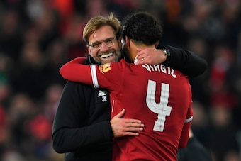 Liverpool's German manager Jurgen Klopp (L) hugs Liverpool's Dutch defender Virgil van Dijk (R) at the end of the English FA Cup third round football match between Liverpool and Everton at Anfield in Liverpool, north west England on January 5, 2018. / AFP