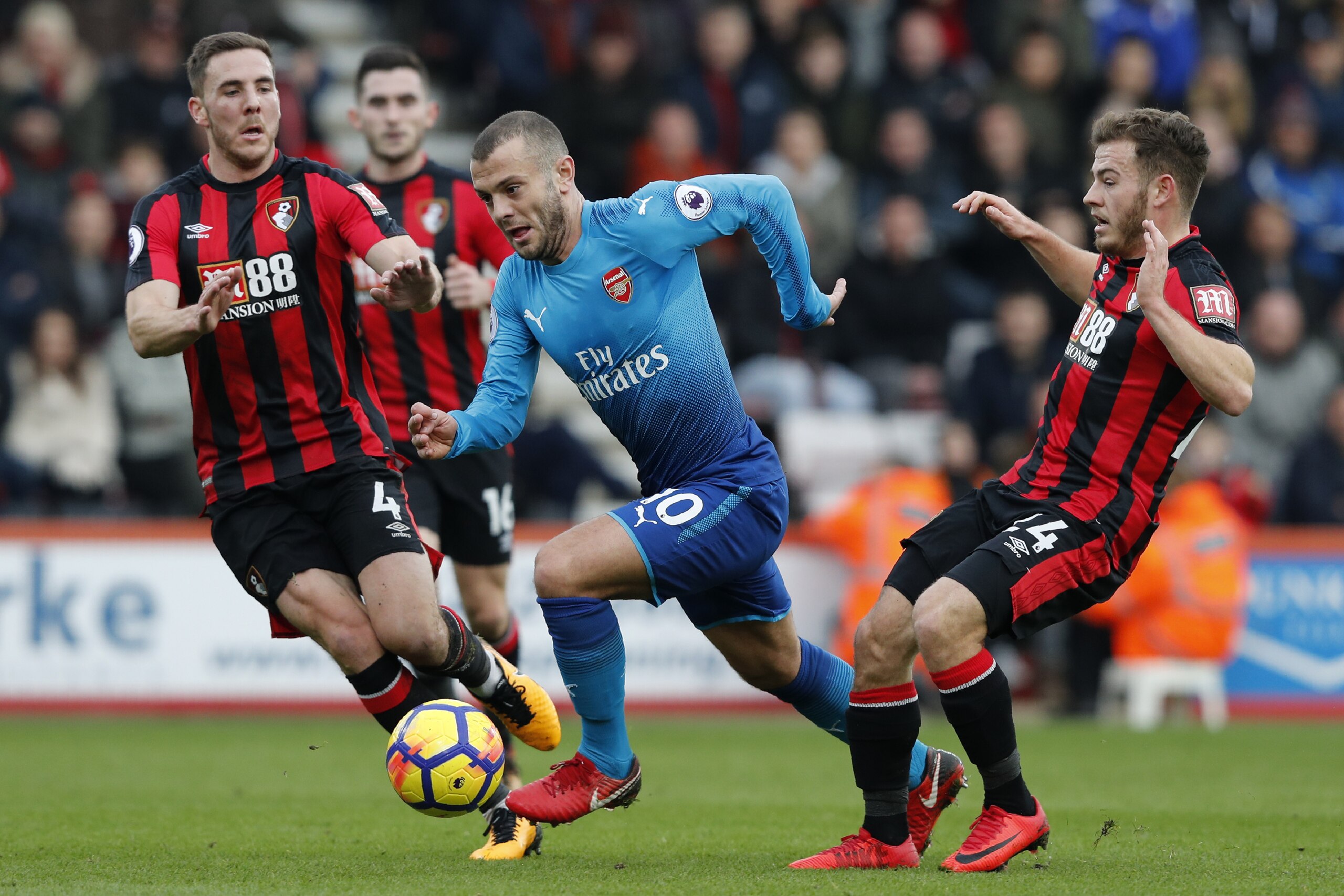 Bournemouth's English midfielder Jack Wilshere (C) vies with Bournemouth's English midfielder Dan Gosling (L) and Bournemouth's Scottish midfielder Ryan Fraser during the English Premier League football match between Bournemouth and Arsenal at the Vitalit