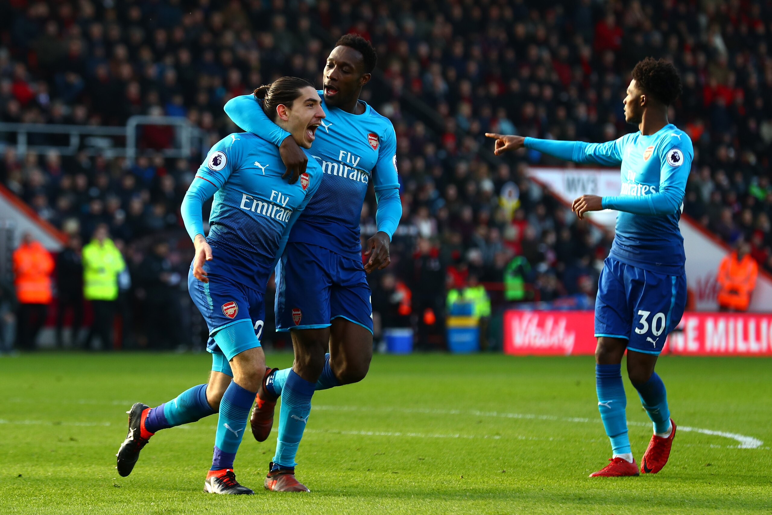 BOURNEMOUTH, ENGLAND - JANUARY 14:  Hector Bellerin of Arsenal celebrates scoring his sides first goal with Danny Welbeck and Ainsley Maitland-Niles of Arsenal during the Premier League match between AFC Bournemouth and Arsenal at Vitality Stadium on Janu