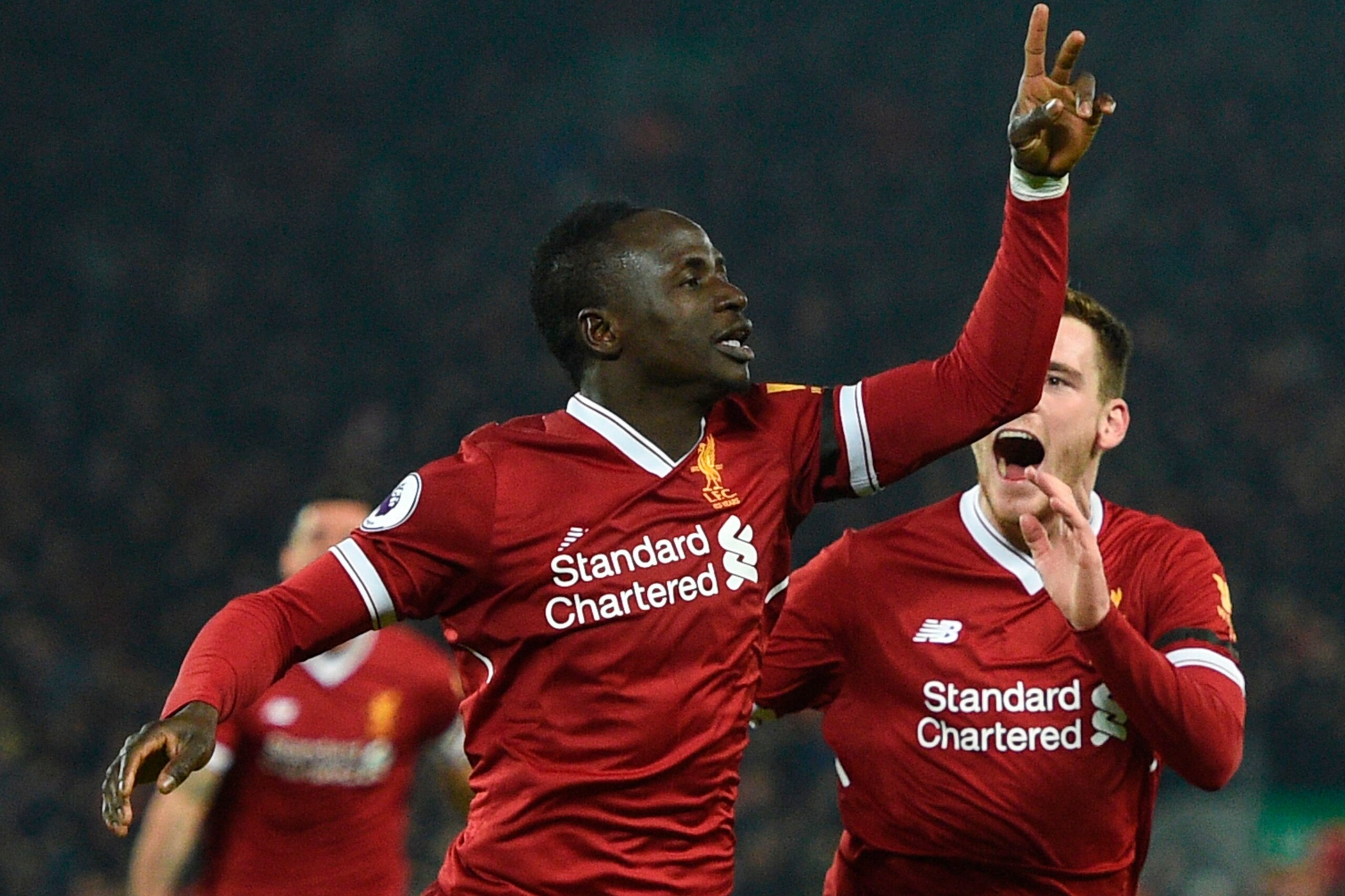 Liverpool's Senegalese midfielder Sadio Mane (L) celebrates scoring their third goal to extend their lead 3-1 with Liverpool's Scottish defender Andrew Robertson (R) during the English Premier League football match between Liverpool and Manchester City at Liverpool's Senegalese midfielder Sadio Mane (L) celebrates scoring their third goal to extend their lead 3-1 with Liverpool's Scottish defender Andrew Robertson (R) during the English Premier League football match between Liverpool and Manchester City at