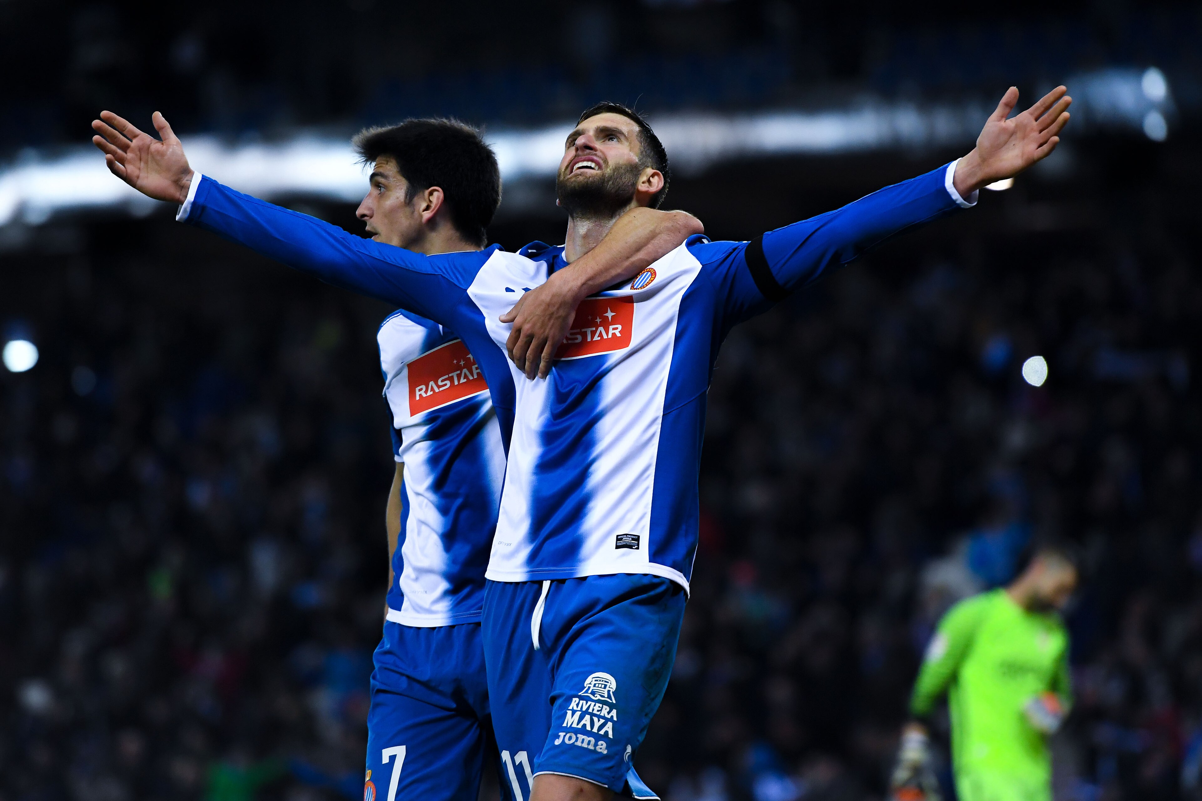 BARCELONA, SPAIN - DECEMBER 11:  Leo Baptistao (R) of RCD Espanyol celebrates with his team mate Gerard Moreno after scoring his team's second goal during the La Liga match between RCD Espanyol and Real Sporting de Gijon at Cornella-El Prat stadium on Dec