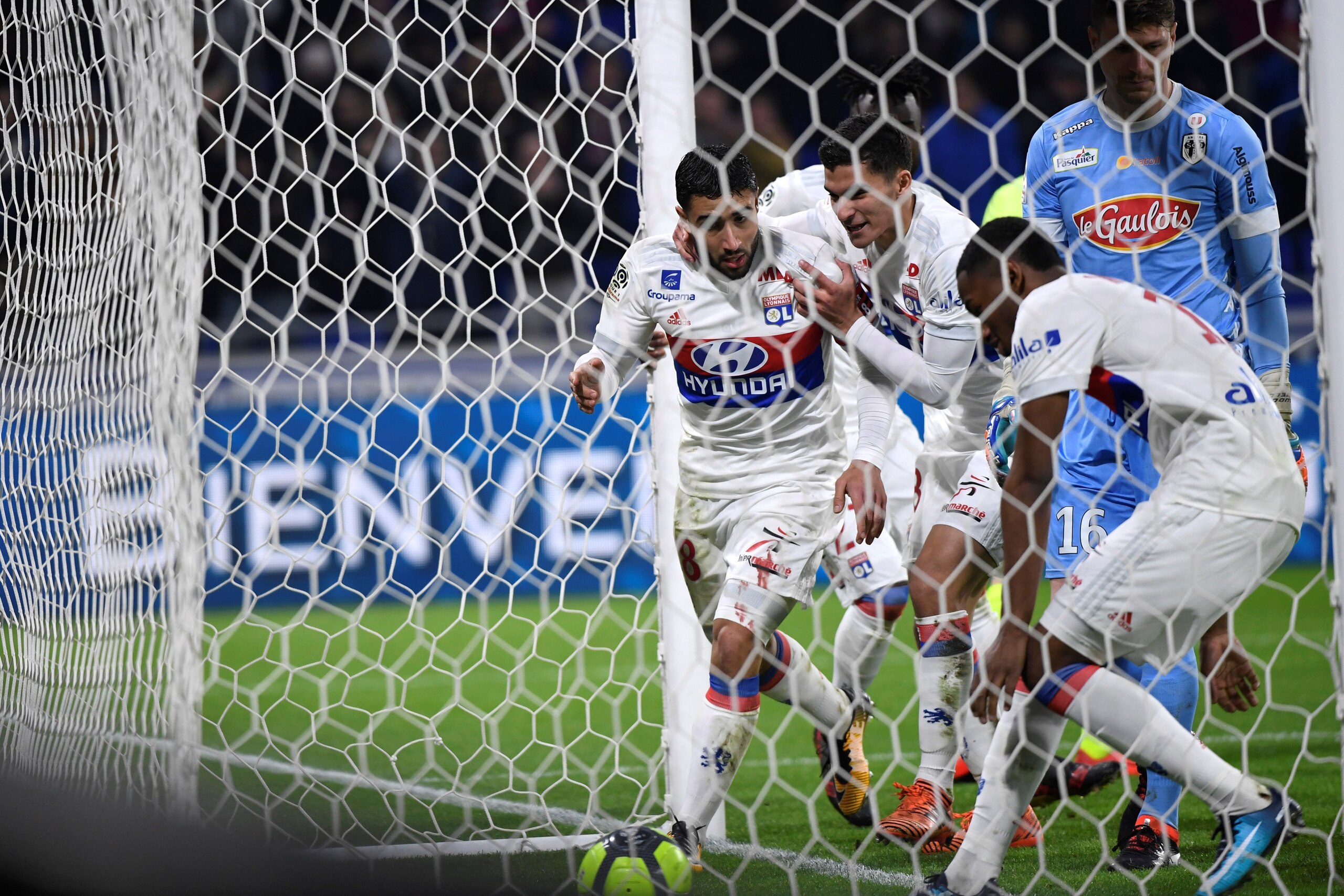 Lyon's French forward Nabil Fekir celebrates (C) is congratulated by teammates after scoring a goal during the French L1 football match between Lyon (OL) and Angers (ASCO) on January 14, 2018, in Decines-Charpieu near Lyon, central-eastern France.  / AFP 