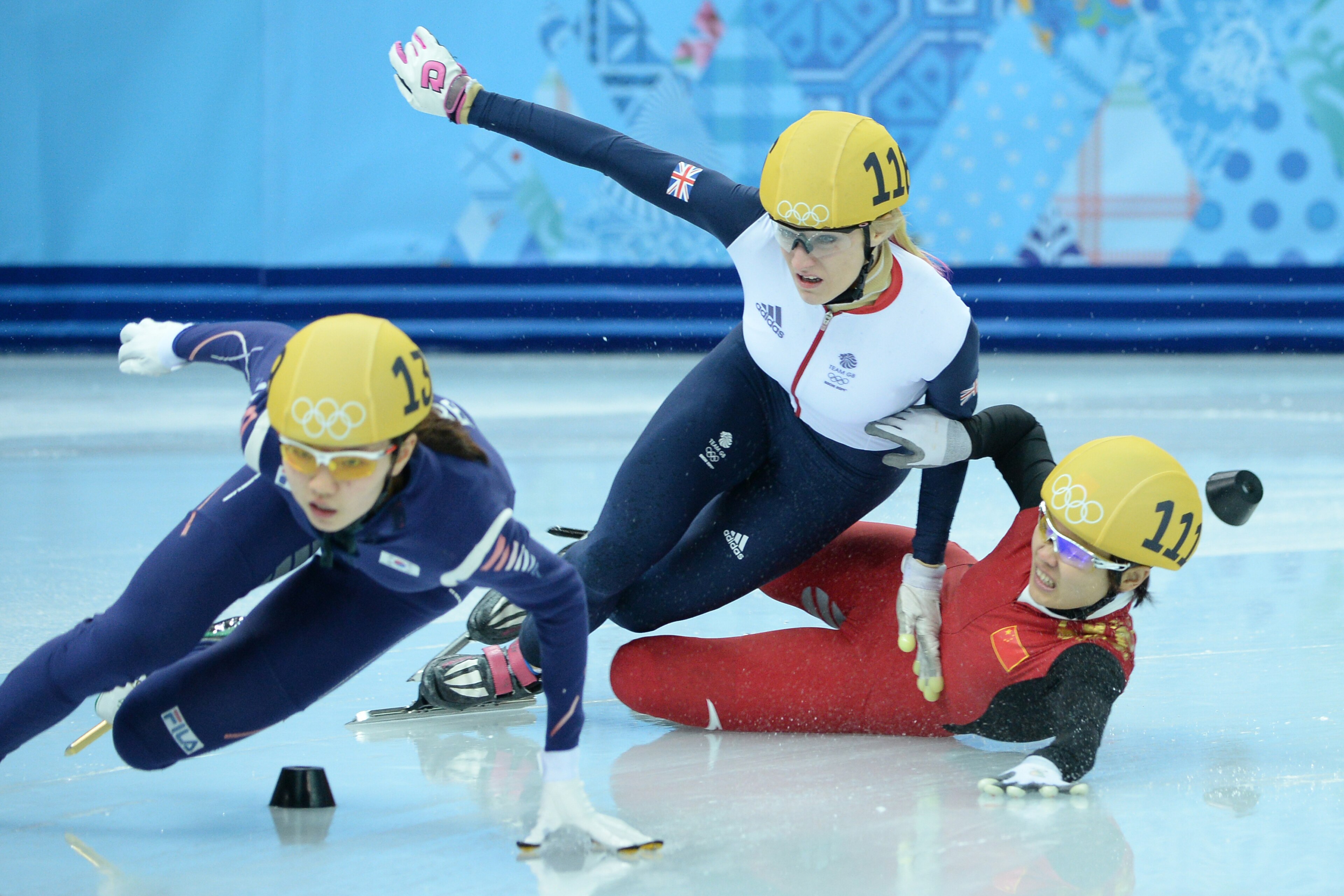 (From L) South Korea's Shim Suk Hee competes as Great Britain's Elise Christie and China's Li Jianrou collide in the Women's Short Track 1000 m Semifinals at the Iceberg Skating Palace during the Sochi Winter Olympics on February 21, 2014. AFP PHOTO / JUN