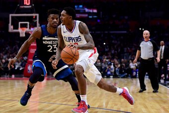 LOS ANGELES, CA - DECEMBER 06:  Lou Williams #23 of the LA Clippers drives to the basket on Jimmy Butler #23 of the Minnesota Timberwolves during a 113-107 Timberwolves win at Staples Center on December 6, 2017 in Los Angeles, California.  (Photo by Harry