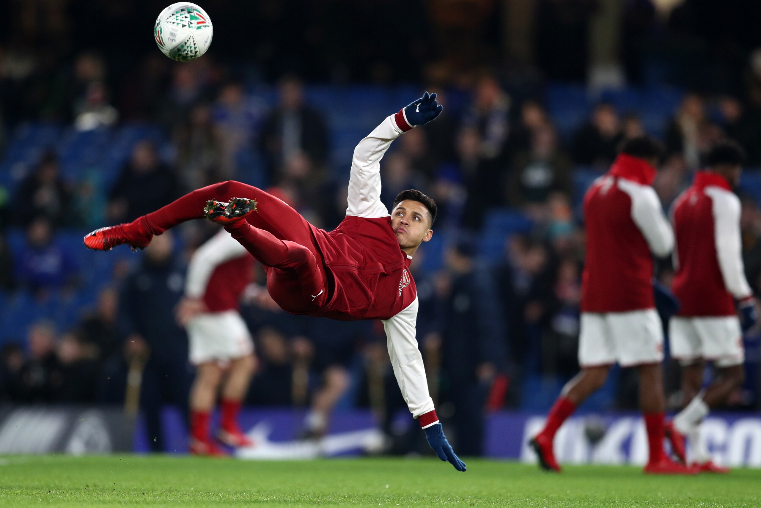 LONDON, ENGLAND - JANUARY 10: Alexis Sanchez of Arsenal tries an overhead kick as he warms up before the Carabao Cup Semi-Final First Leg match between Chelsea and Arsenal at Stamford Bridge on January 10, 2018 in London, England. (Photo by Catherine Ivil LONDON, ENGLAND - JANUARY 10: Alexis Sanchez of Arsenal tries an overhead kick as he warms up before the Carabao Cup Semi-Final First Leg match between Chelsea and Arsenal at Stamford Bridge on January 10, 2018 in London, England. (Photo by Catherine Ivil