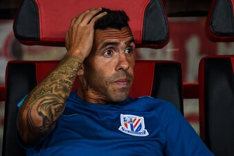 Shanghai Shenhua's Carlos Tevez looks on during the 2017 Chinese Super League football match between Shanghai East Asia (SIPG) FC and Shanghai Shenhua in Shanghai on September 16, 2017. / AFP PHOTO / CHANDAN KHANNA / China OUT / XGTY        (Photo credit 