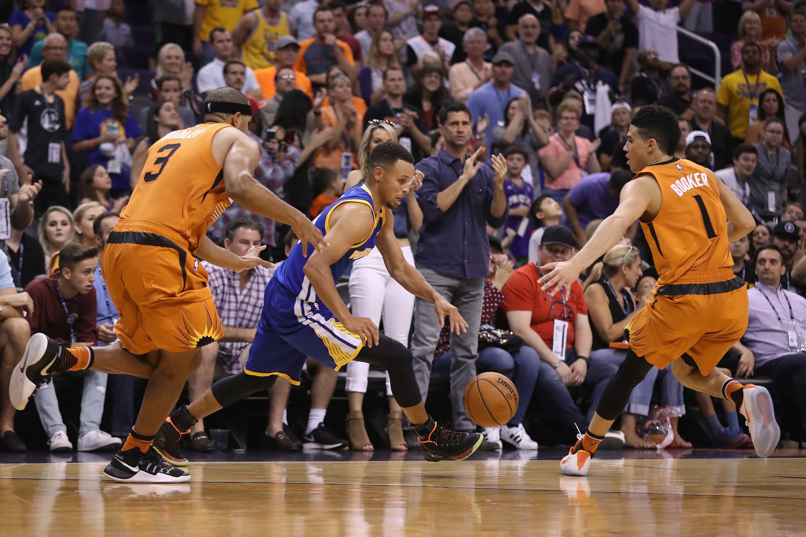 PHOENIX, AZ - OCTOBER 30:  Stephen Curry #30 of the Golden State Warriors is fouled by Jared Dudley #3 of the Phoenix Suns during the final moments of the second half of the NBA game at Talking Stick Resort Arena on October 30, 2016 in Phoenix, Arizona.  