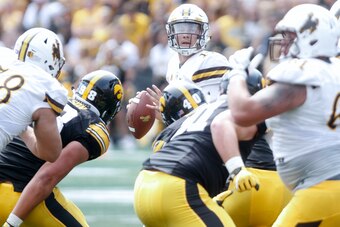 IOWA CITY, IOWA- SEPTEMBER 2:  Quarterback Josh Allen #17 of the Wyoming Cowboys looks for a receiver in the fourth quarter against the Iowa Hawkeyes, on September 2, 2017 at Kinnick Stadium in Iowa City, Iowa.  (Photo by Matthew Holst/Getty Images)