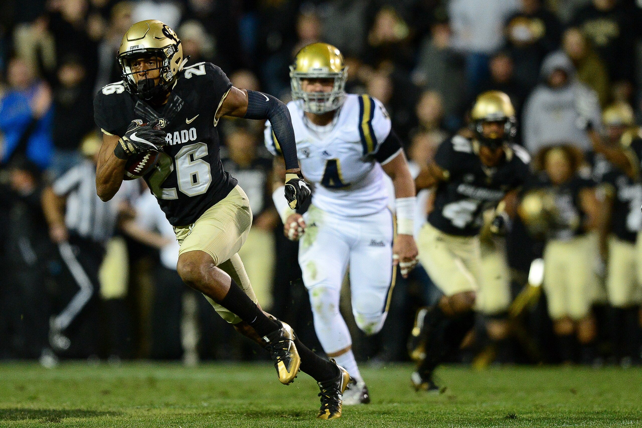 BOULDER, CO - NOVEMBER 3:  Defensive back Isaiah Oliver #26 of the Colorado Buffaloes returns a punt for yardage against the UCLA Bruins at Folsom Field on November 3, 2016 in Boulder, Colorado.  (Photo by Dustin Bradford/Getty Images)
