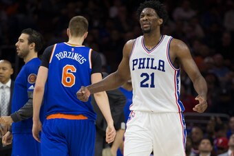 PHILADELPHIA, PA - JANUARY 11: Joel Embiid #21 of the Philadelphia 76ers reacts in front of Kristaps Porzingis #6 of the New York Knicks in the second quarter during a timeout at the Wells Fargo Center on January 11, 2017 in Philadelphia, Pennsylvania. NO