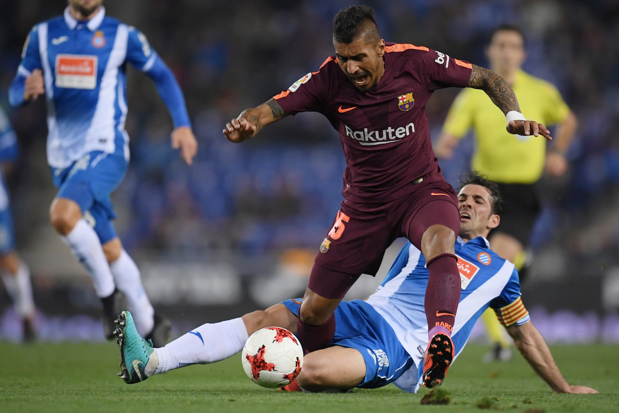 BARCELONA, SPAIN - JANUARY 17:  Paulinho of Barcelona is tackled by Victor Sanchez of Espanyol  during the Spanish Copa del Rey Quarter Final First Leg match between Espanyol and Barcelona at Nuevo Estadio de Cornella-El Prat on January 17, 2018 in Barcel