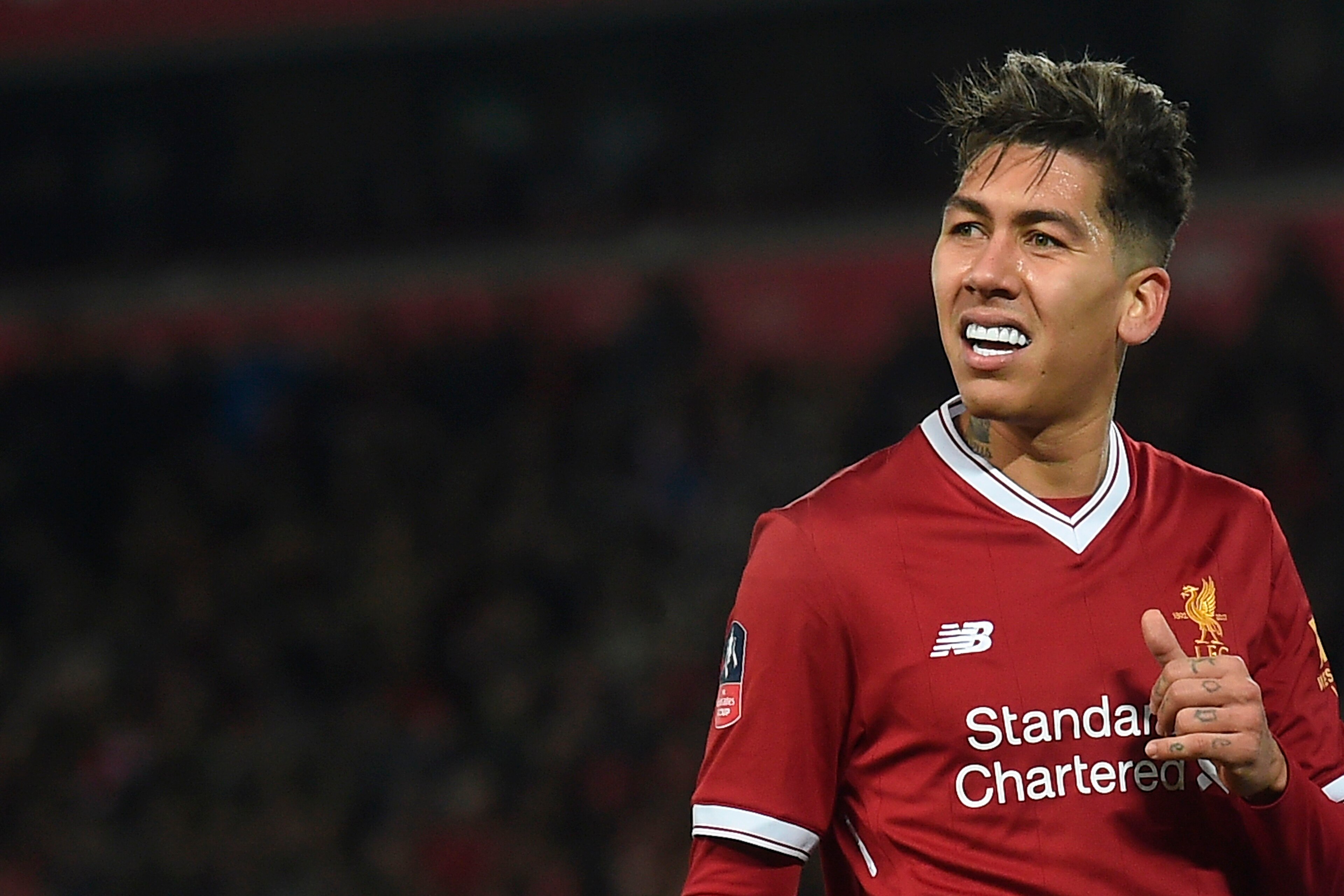 Liverpool's Brazilian midfielder Roberto Firmino reacts during the English FA Cup third round football match between Liverpool and Everton at Anfield in Liverpool, north west England on January 5, 2018. / AFP PHOTO / PAUL ELLIS / RESTRICTED TO EDITORIAL U