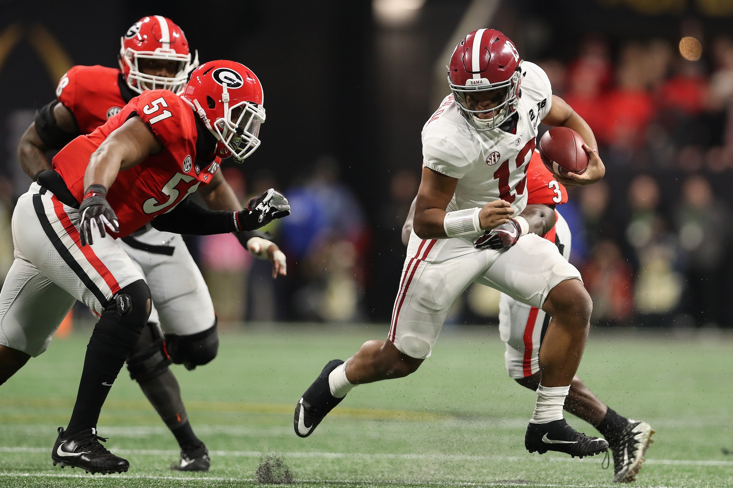 ATLANTA, GA - JANUARY 08:  Quarterback Tua Tagovailoa #13 of the Alabama Crimson Tide scrambles with the football against the Georgia Bulldogs during the CFP National Championship presented by AT&T at Mercedes-Benz Stadium on January 8, 2018 in Atlanta, G