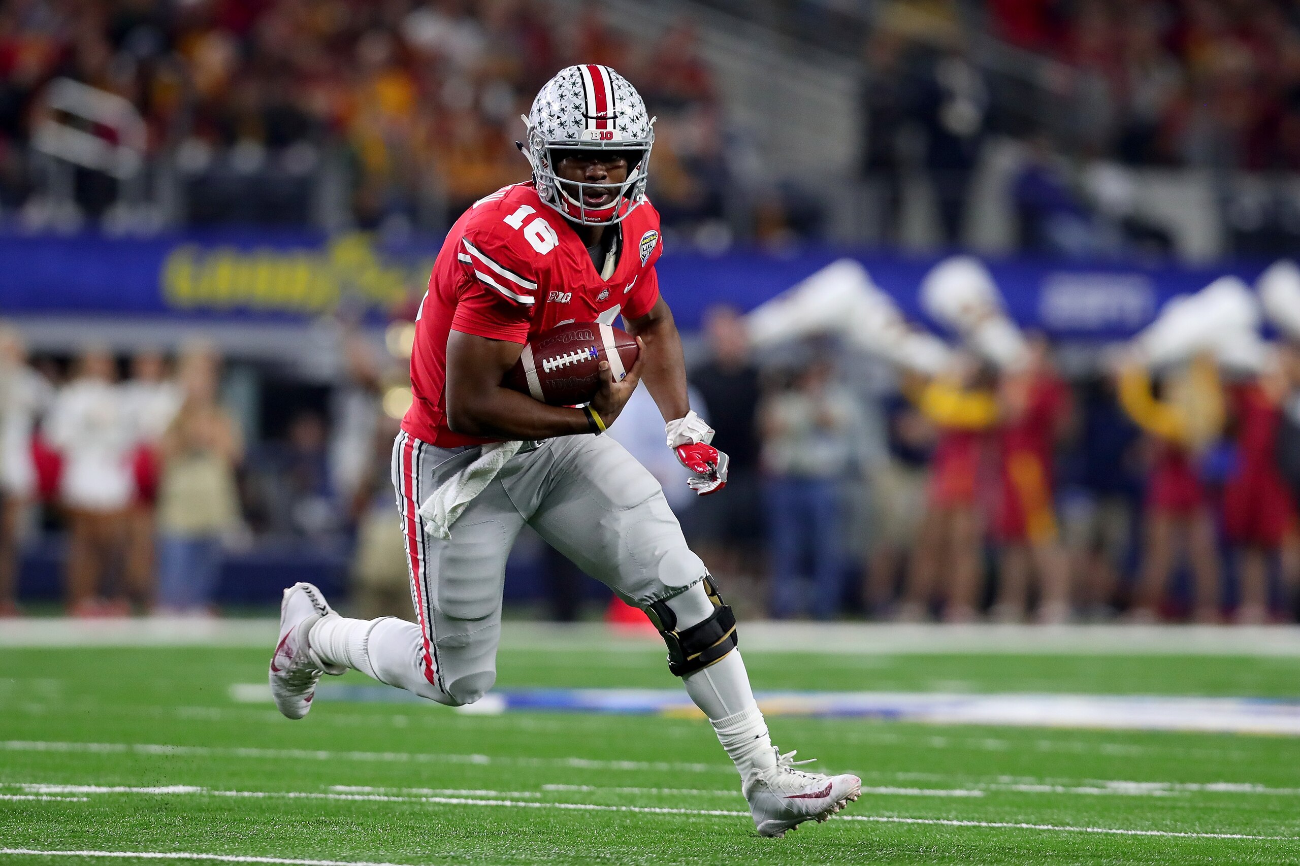 ARLINGTON, TX - DECEMBER 29:  J.T. Barrett #16 of the Ohio State Buckeyes scores a touchdown against the USC Trojans in the first half during the Goodyear Cotton Bowl Classic at AT&T Stadium on December 29, 2017 in Arlington, Texas.  (Photo by Tom Penning