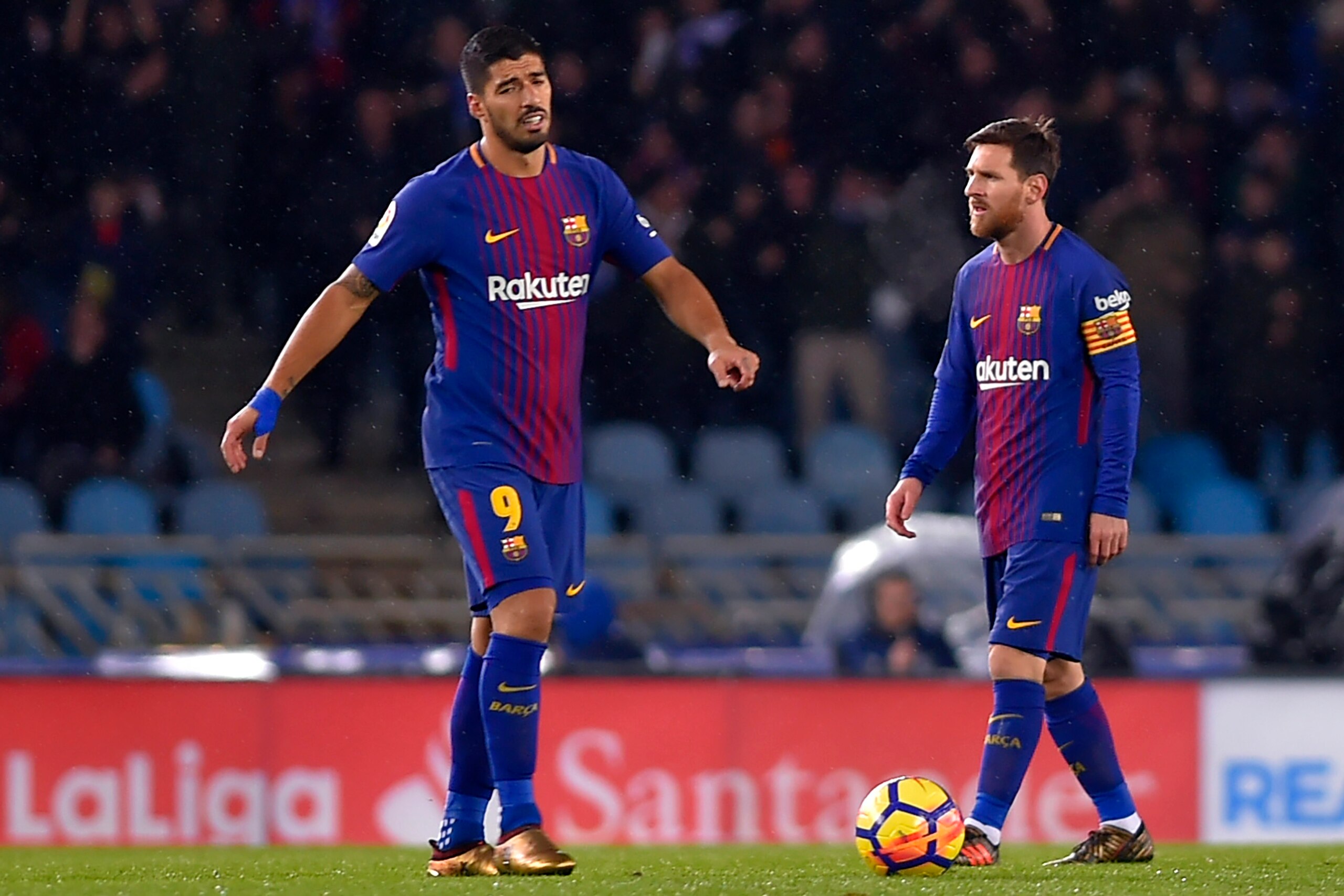 Barcelona's Uruguayan forward Luis Suarez (L) gestures beside  Argentinian forward Lionel Messi following Real Sociedad's opening goal during the Spanish league football match between Real Sociedad and FC Barcelona at the Anoeta stadium in San Sebastian o