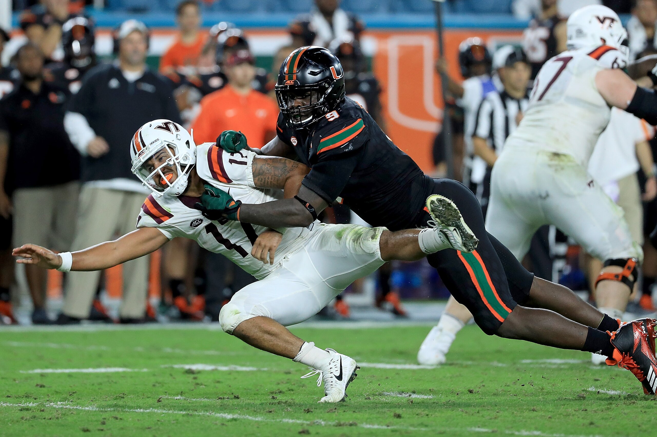 MIAMI GARDENS, FL - NOVEMBER 04: Josh Jackson #17 of the Virginia Tech Hokies is tackled by Chad Thomas #9 of the Miami Hurricanes during a game  at Hard Rock Stadium on November 4, 2017 in Miami Gardens, Florida.  (Photo by Mike Ehrmann/Getty Images)