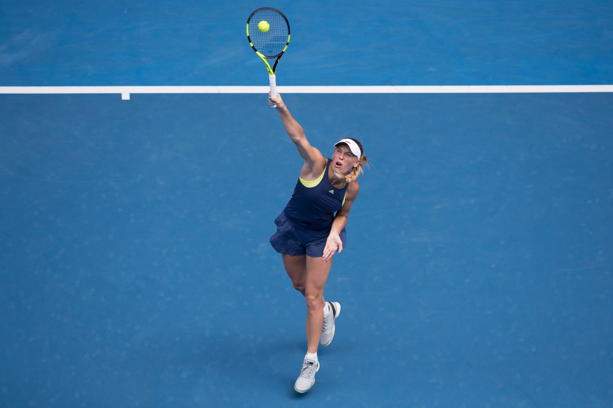 MELBOURNE, AUSTRALIA - JANUARY 21:  Caroline Wozniacki of Denmark plays a forehand in her fourth round match against Magdalena Rybarikova of Slovakia on day seven of the 2018 Australian Open at Melbourne Park on January 21, 2018 in Melbourne, Australia.  