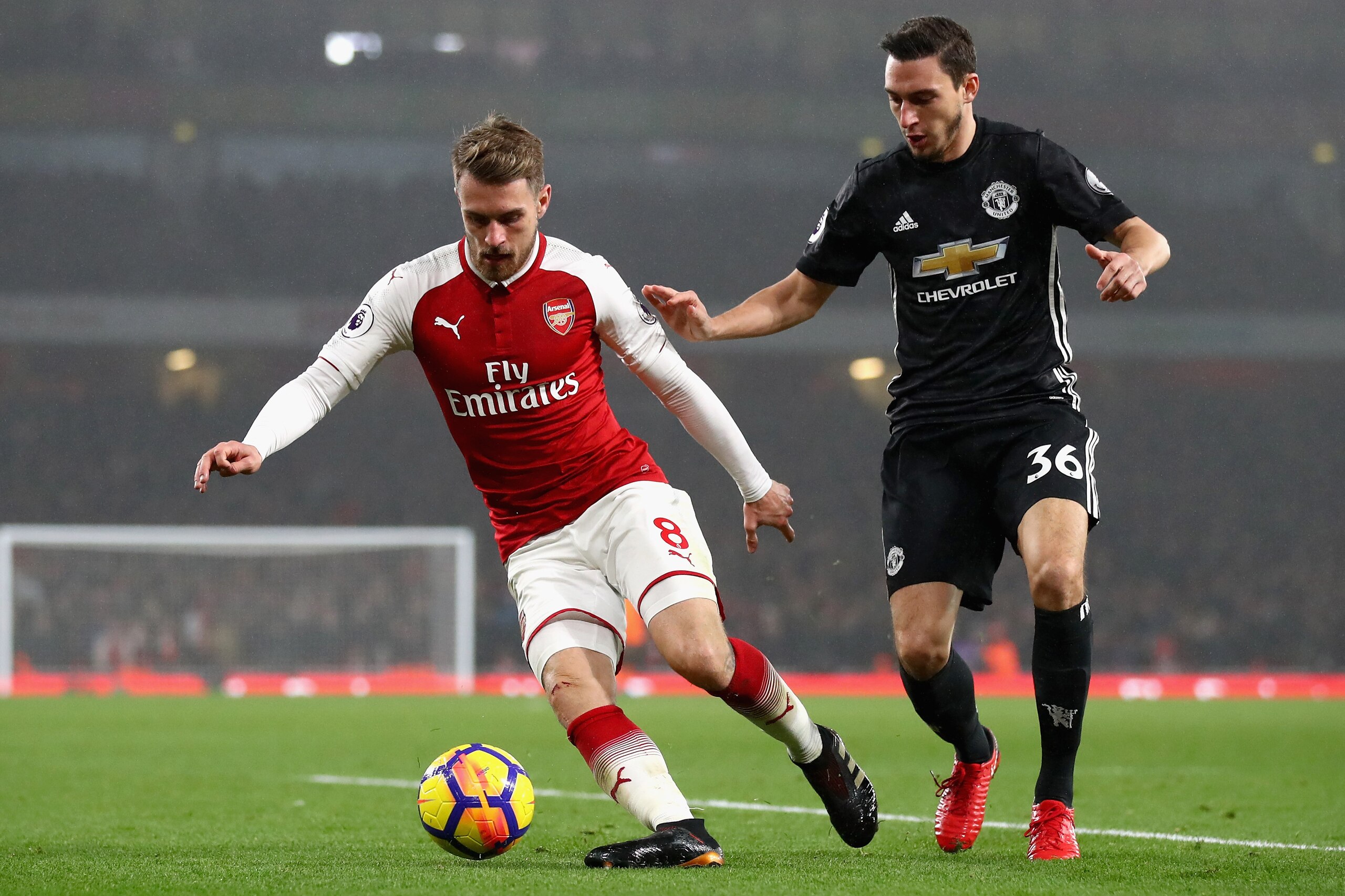 LONDON, ENGLAND - DECEMBER 02: Aaron Ramsey of Arsenal is challenged by Matteo Darmian of Manchester United during the Premier League match between Arsenal and Manchester United at Emirates Stadium on December 2, 2017 in London, England.  (Photo by Julian