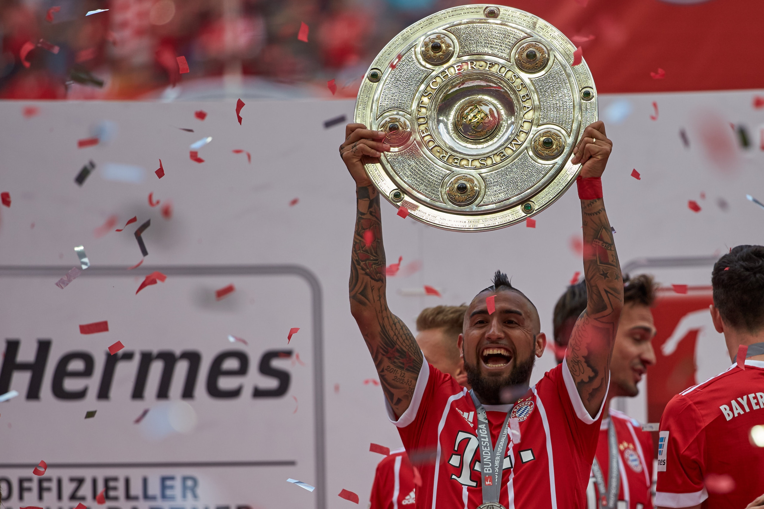 MUNICH, GERMANY - MAY 20: Arturo Vidal of Bayern Muenchen poses with the Championship trophy in celebration of the 67th German Championship title following the Bundesliga match between Bayern Muenchen and SC Freiburg at Allianz Arena on May 20, 2017 in Mu