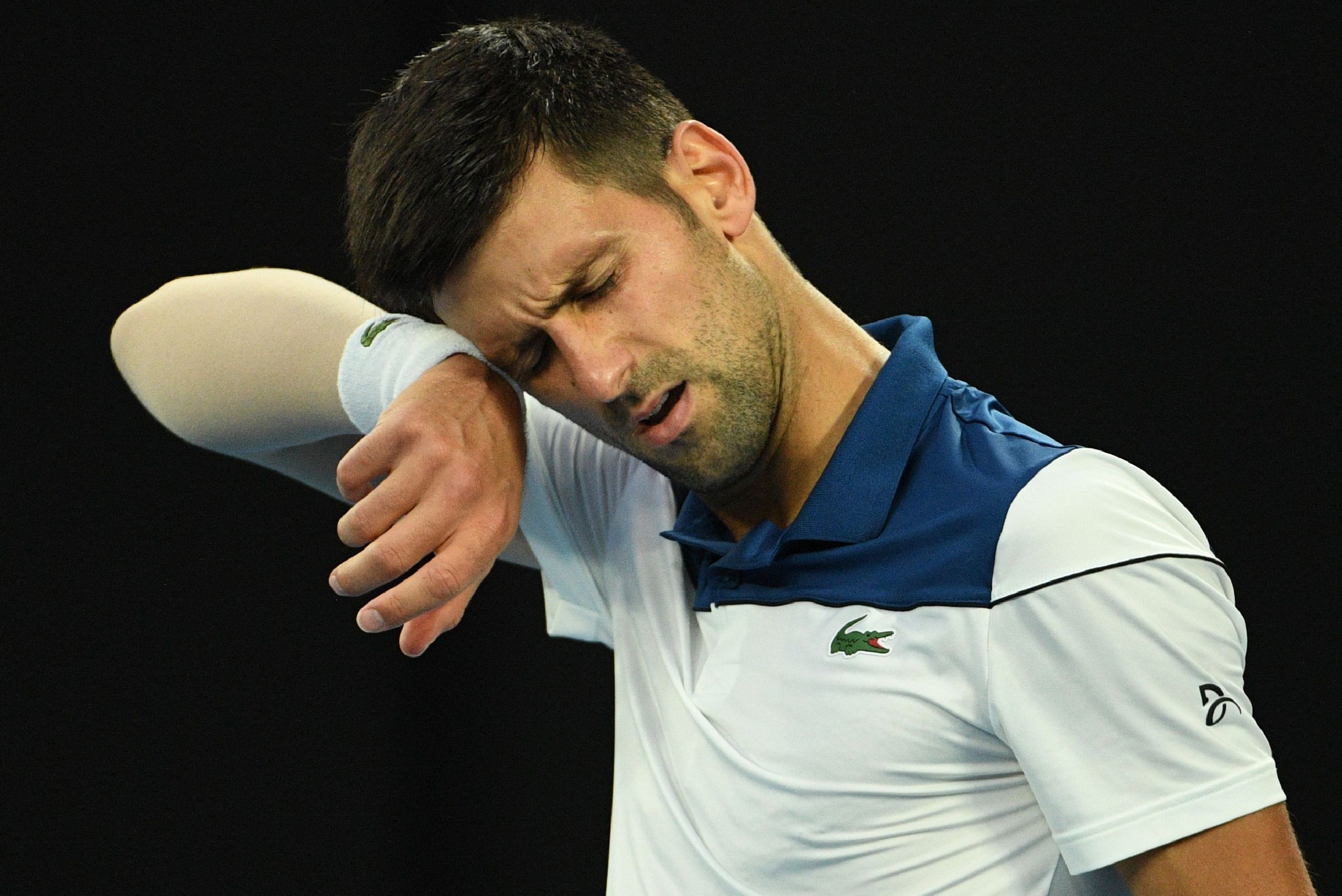 Serbia's Novak Djokovic reacts during their men's singles fourth round match against South Korea's Hyeon Chung on day eight of the Australian Open tennis tournament in Melbourne on January 22, 2018. / AFP PHOTO / SAEED KHAN / -- IMAGE RESTRICTED TO EDITOR