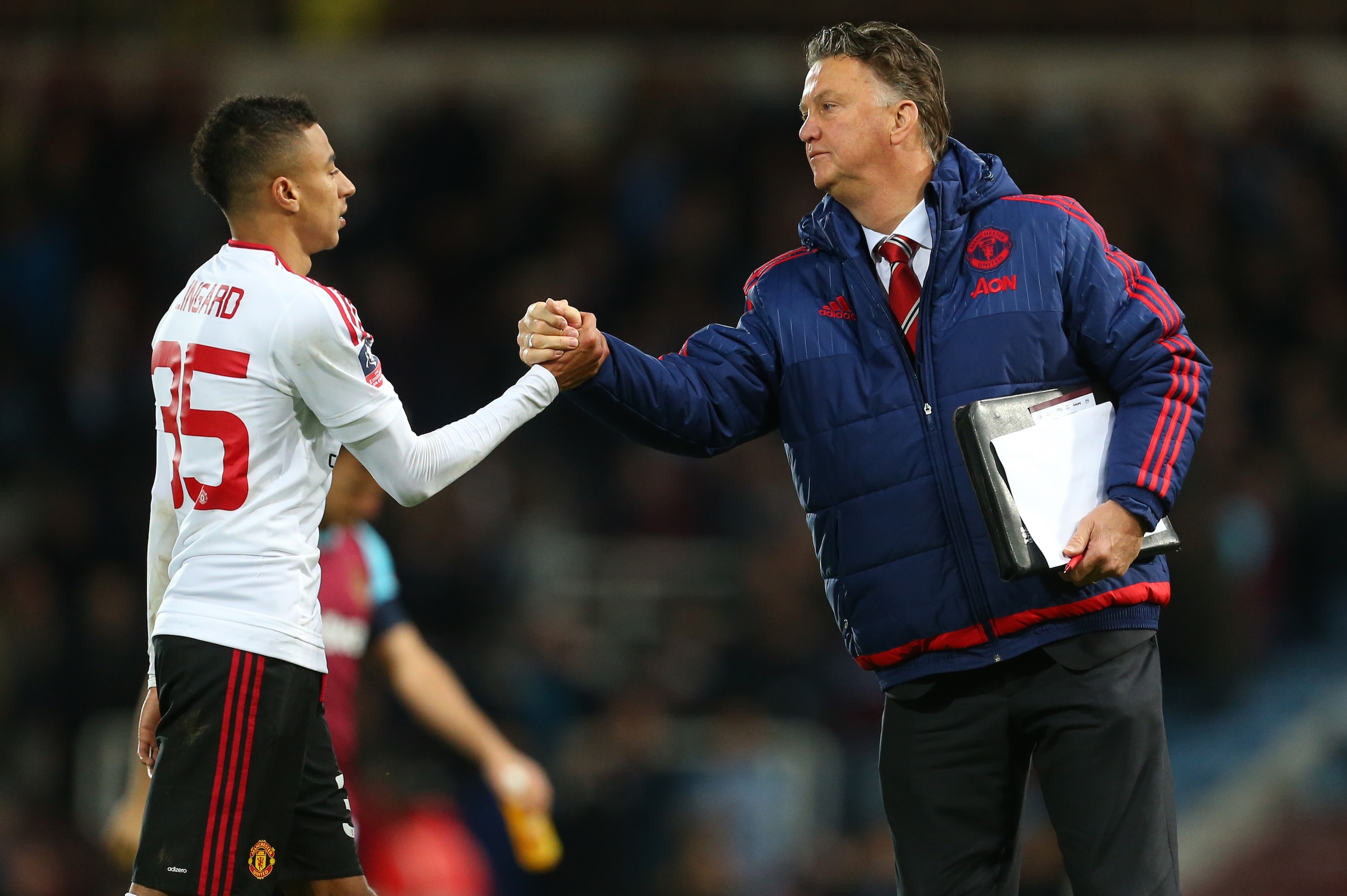 LONDON, ENGLAND - APRIL 13: Louis van Gaal Manager of Manchester United and Jesse Lingard of Manchester United after the Emirates FA Cup Sixth Round Replay match between West Ham United and Manchester United at Boleyn Ground on April 13, 2016 in London, E