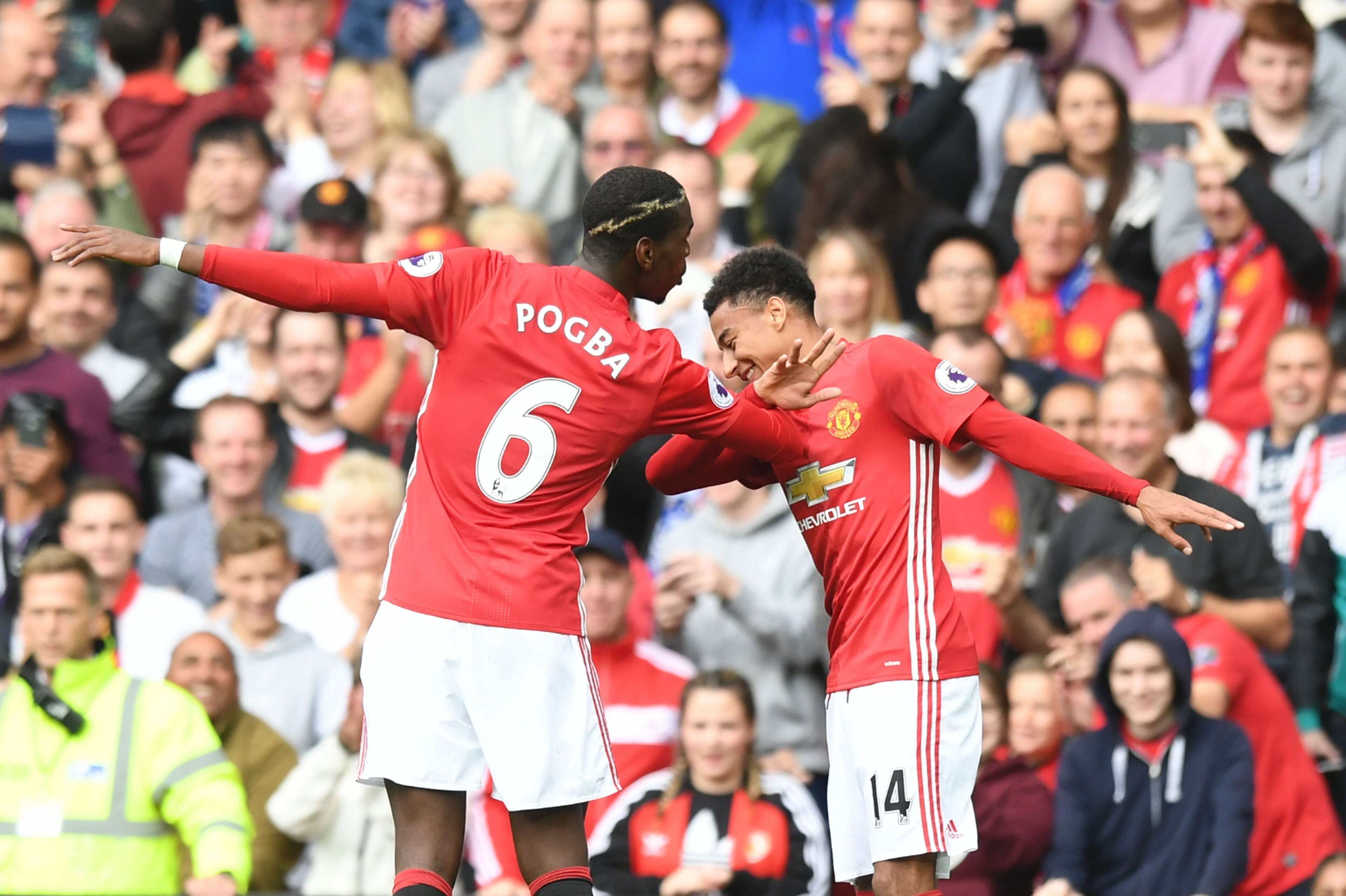 Manchester United's French midfielder Paul Pogba (L) and Manchester United's English midfielder Jesse Lingard (R) celebrate after Pogba scored their fourth goal during the English Premier League football match between Manchester United and Leicester City 