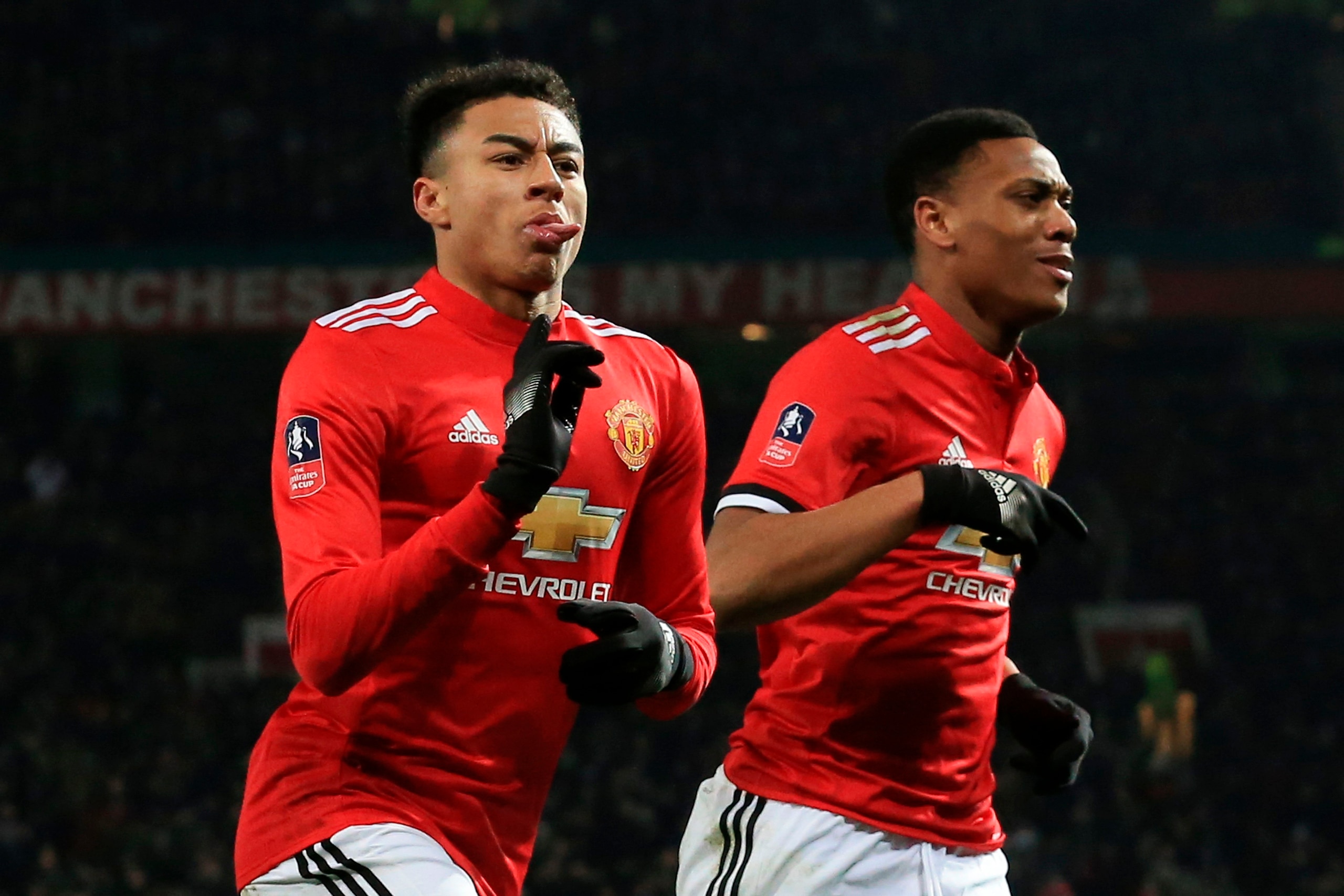 Manchester United's English midfielder Jesse Lingard (L) celebrates scoring the opening goal during the English FA Cup third round football match between Manchester United and Derby County at Old Trafford in Manchester, north west England, on January 5, 2