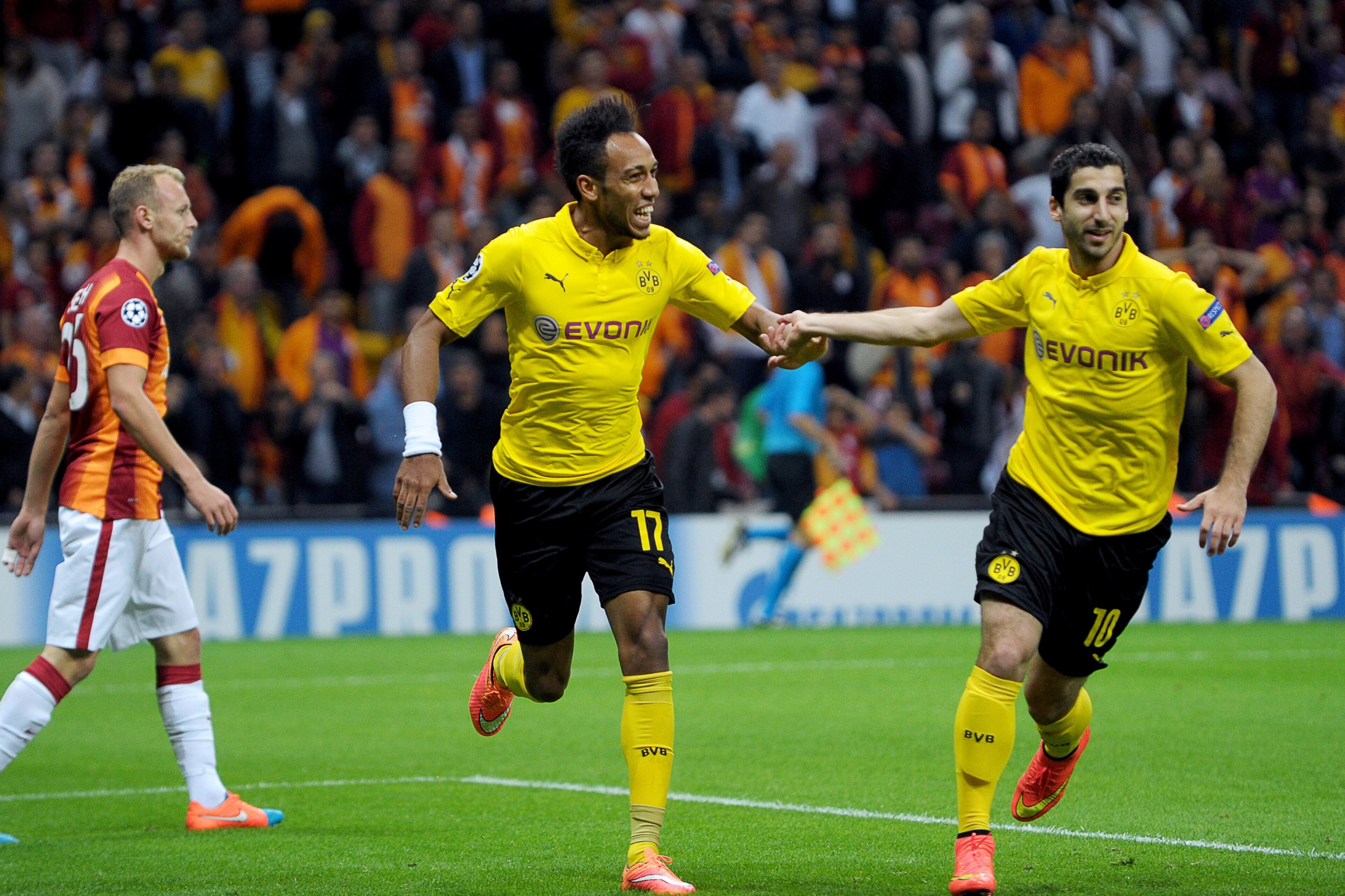 Dortmund's Gabonese forward Pierre-Emerick Aubameyang celebrates (C) with Dortmund's Armenian forward Henrikh Mkhitaryan (R) after scoring a goal during the UEFA Champions League Group D football match between Galatasaray and Borrusia Dortmund on October 