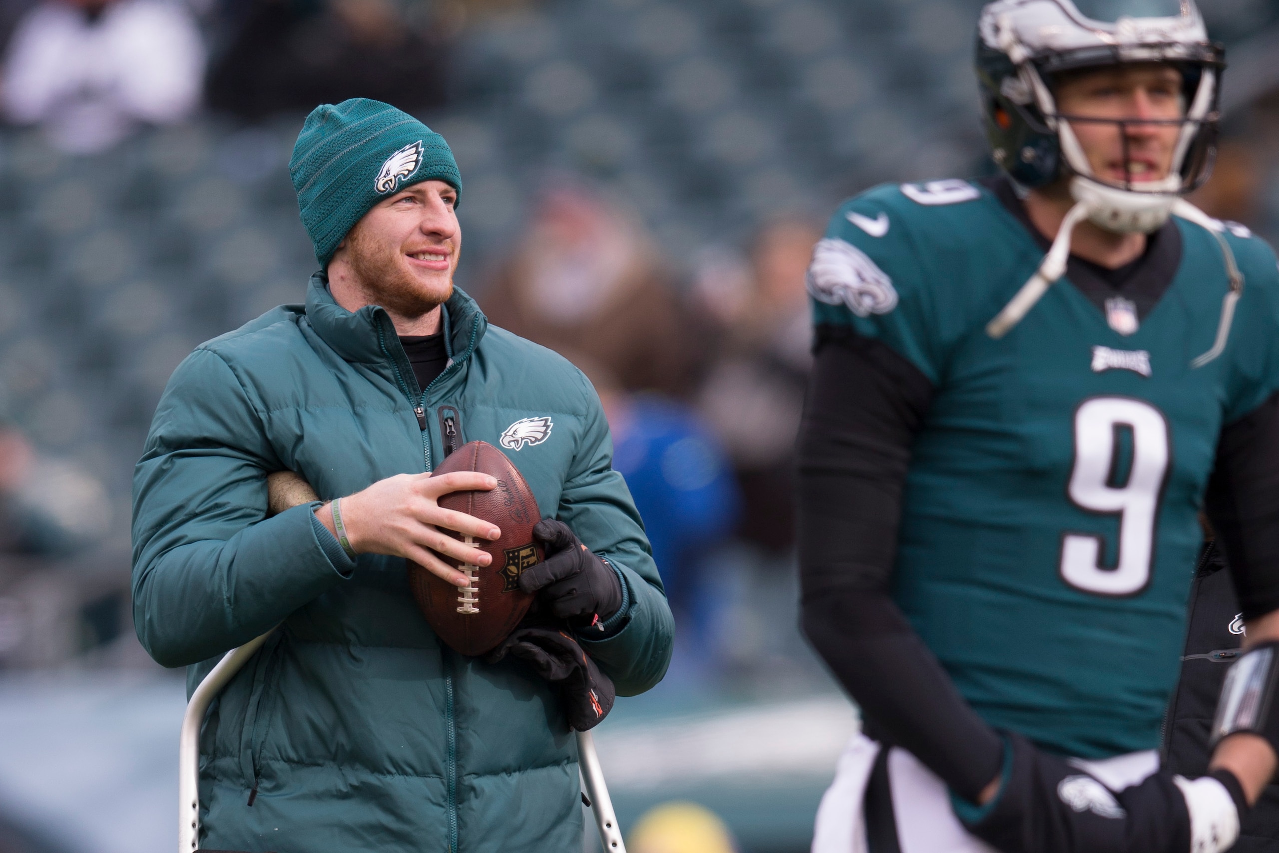 PHILADELPHIA, PA - DECEMBER 31: Quarterback Nick Foles #9 (R) of the Philadelphia Eagles warms up as injured quarterback Carson Wentz #11 (L) looks on before the game against the Dallas Cowboys at Lincoln Financial Field on December 31, 2017 in Philadelph