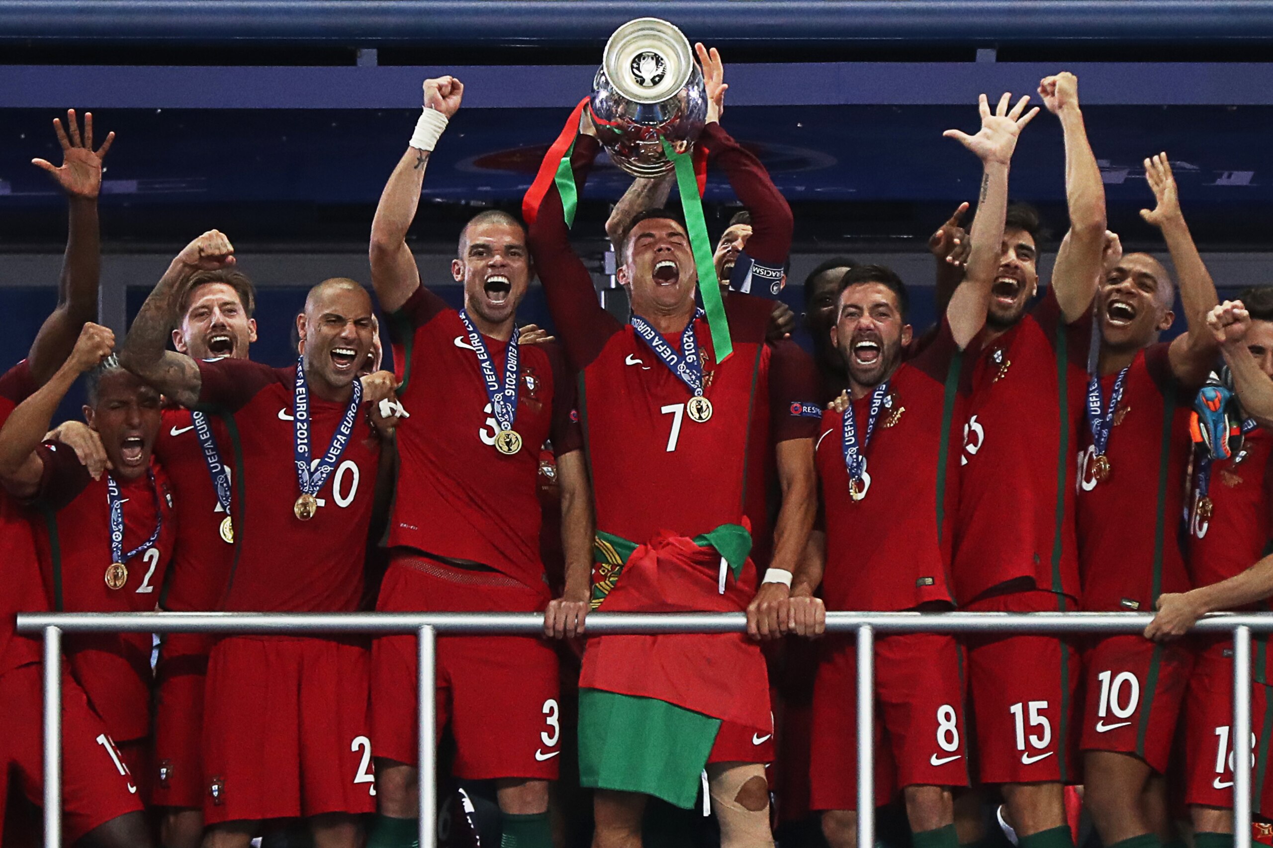 (From R) Portugal's midfielder Joao Mario, Portugal's midfielder Andre Gomes, Portugal's midfielder Joao Moutinho, Portugal's forward Cristiano Ronaldo, Portugal's defender Pepe and Portugal's forward Ricardo Quaresma pose with the trophy after Portugal b