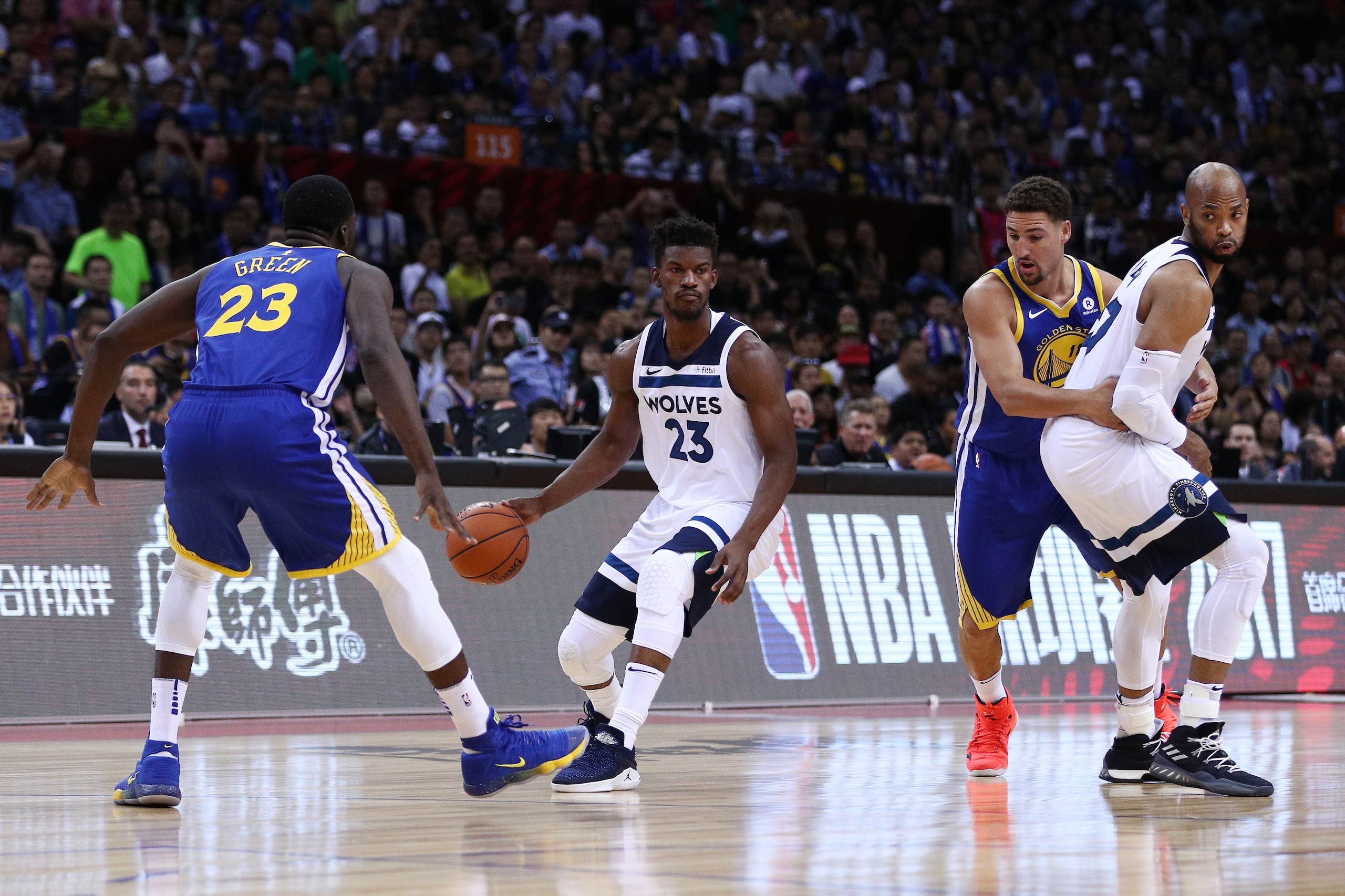 SHENZHEN, CHINA - OCTOBER 05: Jimmy Butler #23 and Taj Gibson #67 of the Minnesota Timberwolves in action against Klay Thompson #11 and Draymond Green #23 of the Golden State Warriors during the game between the Minnesota Timberwolves and the Golden State