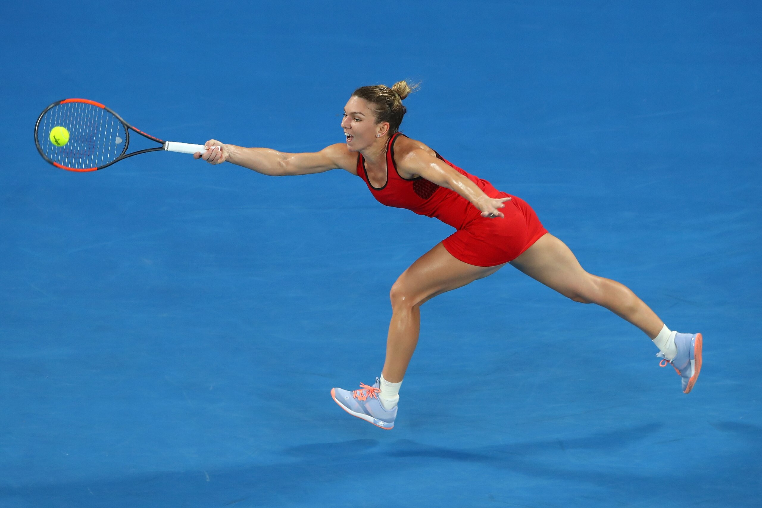 MELBOURNE, AUSTRALIA - JANUARY 27:  Simona Halep of Romania plays a forehand in her women's singles final against Caroline Wozniacki of Denmark on day 13 of the 2018 Australian Open at Melbourne Park on January 27, 2018 in Melbourne, Australia.  (Photo by