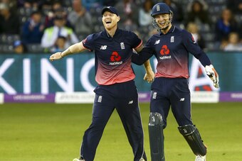 England players Ben Stokes (L) and Jos Buttler celebrate taking the wicket of West Indian Batsman Jerome Taylor during the third one day international cricket match played between England and the West Indies at the Brightside Ground in Bristol on Septembe
