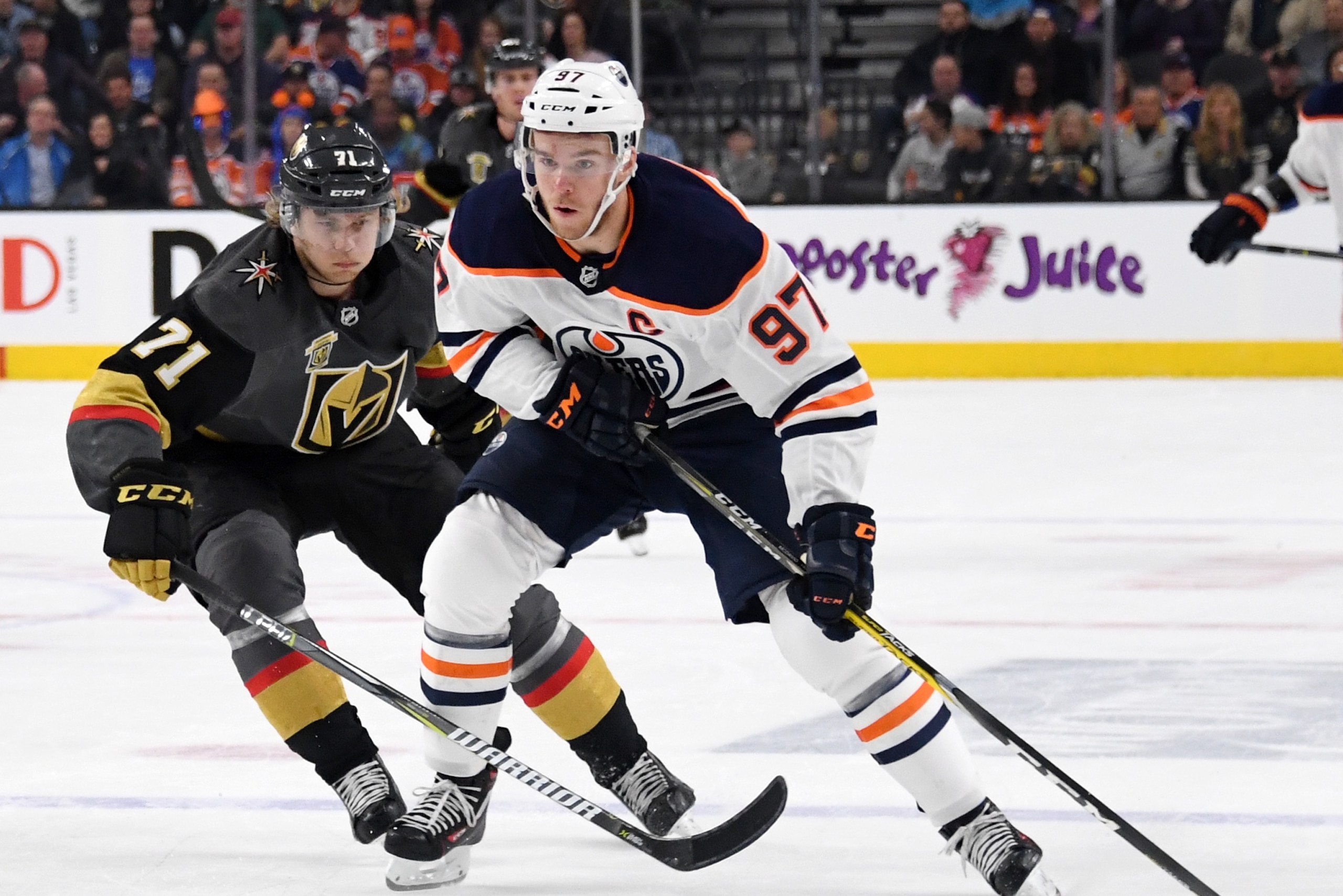 LAS VEGAS, NV - JANUARY 13:  Connor McDavid #97 of the Edmonton Oilers skates with the puck against William Karlsson #71 of the Vegas Golden Knights in the first period of their game at T-Mobile Arena on January 13, 2018 in Las Vegas, Nevada. The Oilers w