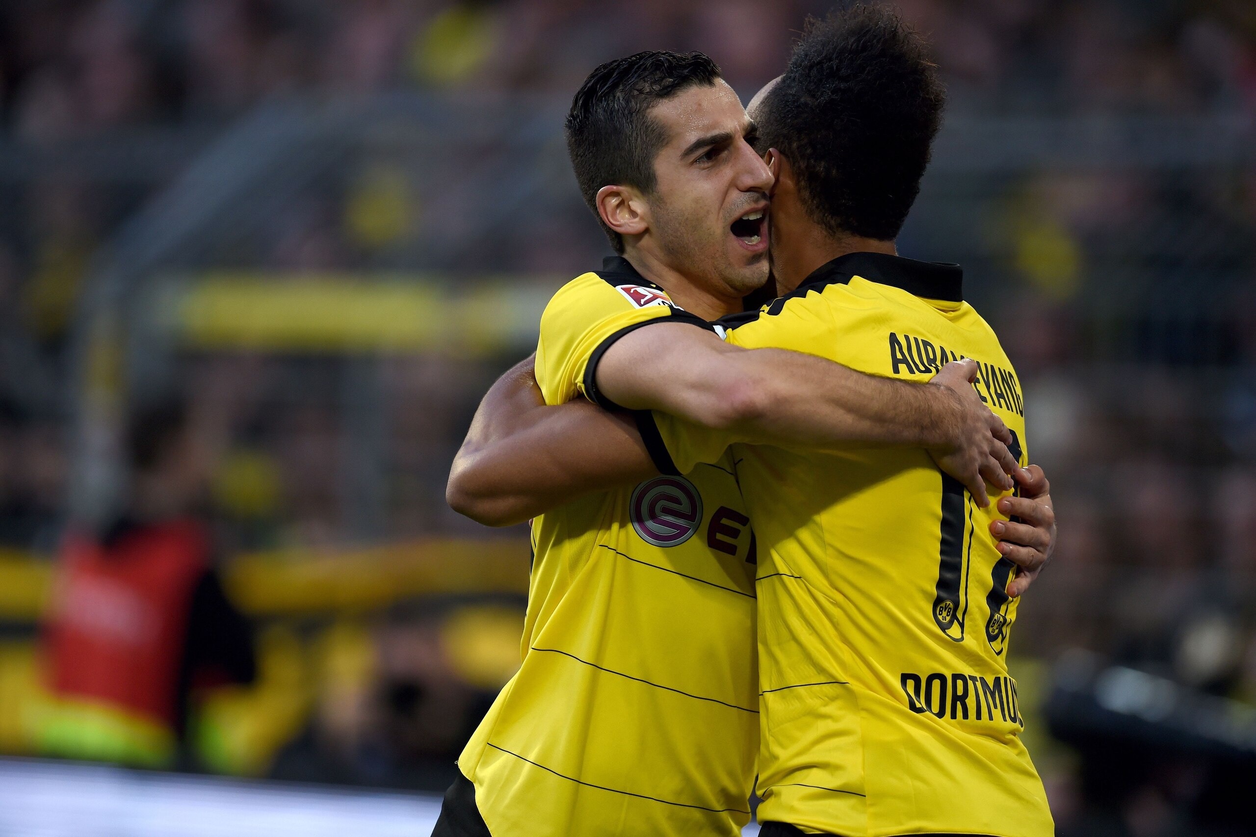Dortmund's Gabonese striker Pierre-Emerick Aubameyang (R) celebrates with Dortmund's Armenian midfielder Henrikh Mkhitaryan after scoring during the German Bundesliga first division football match between Borussia Dortmund and Werder Bremen in Dortmund, w