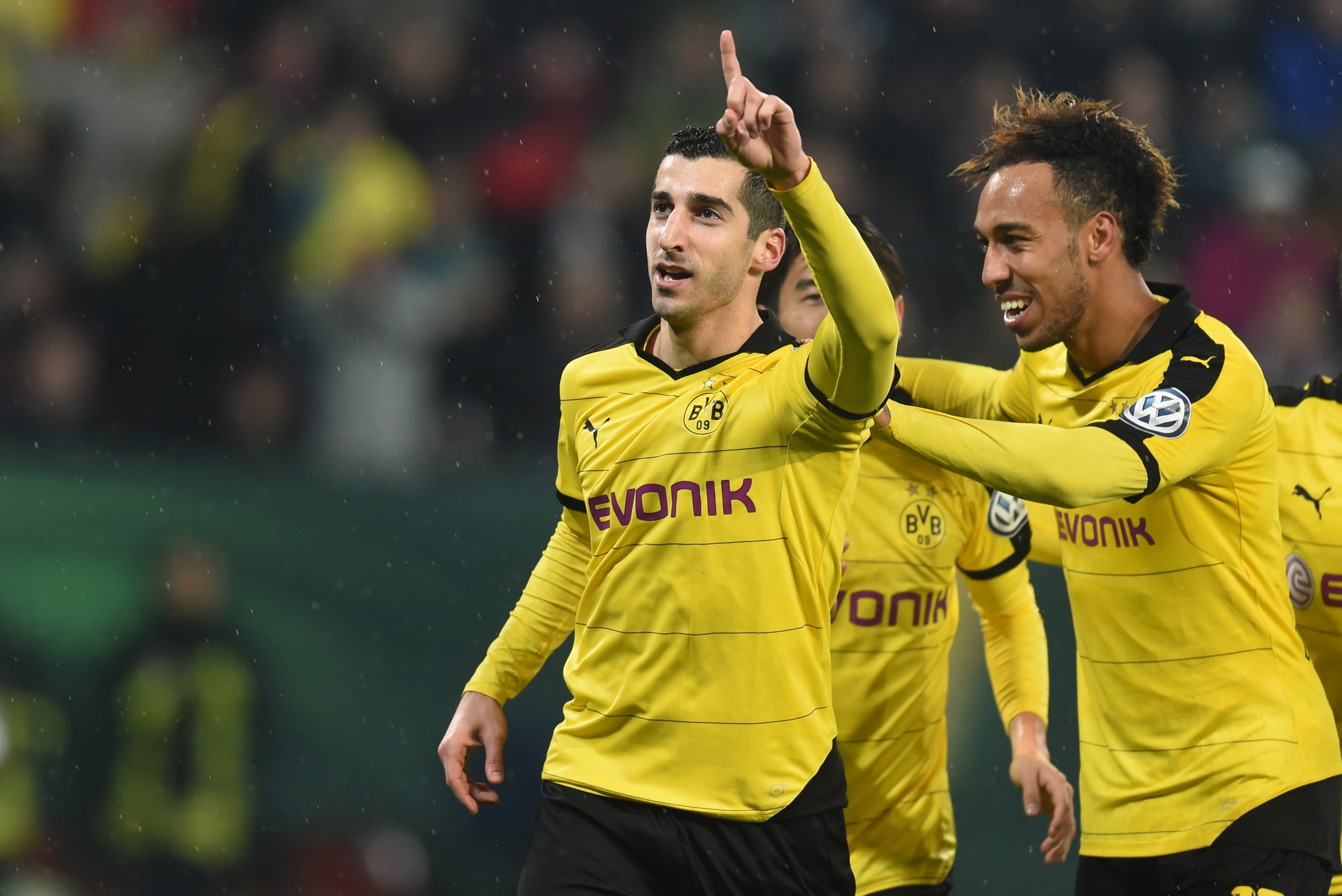 (L-R) Dortmund's Armenian midfielder Henrikh Mkhitaryan, Dortmund's Gabonese striker Pierre-Emerick Aubameyang celebrate after the second goal during the German Cup DFB Pokal third round match between Borussia Dortmund and FC Augsburg in Augsburg on Decem