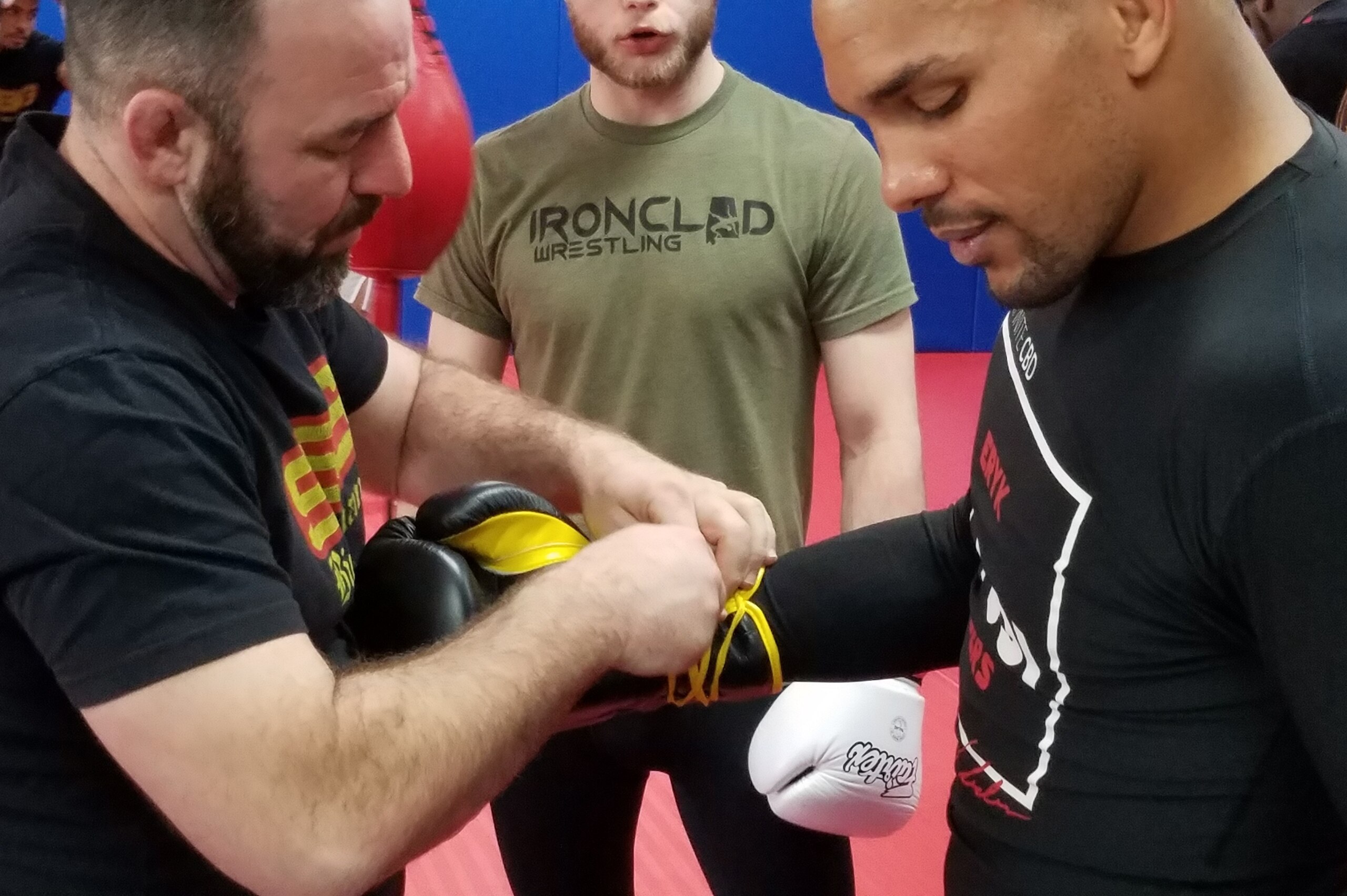 Conolley helps Anders gear up for sparring. Conolley helps Anders gear up for sparring.