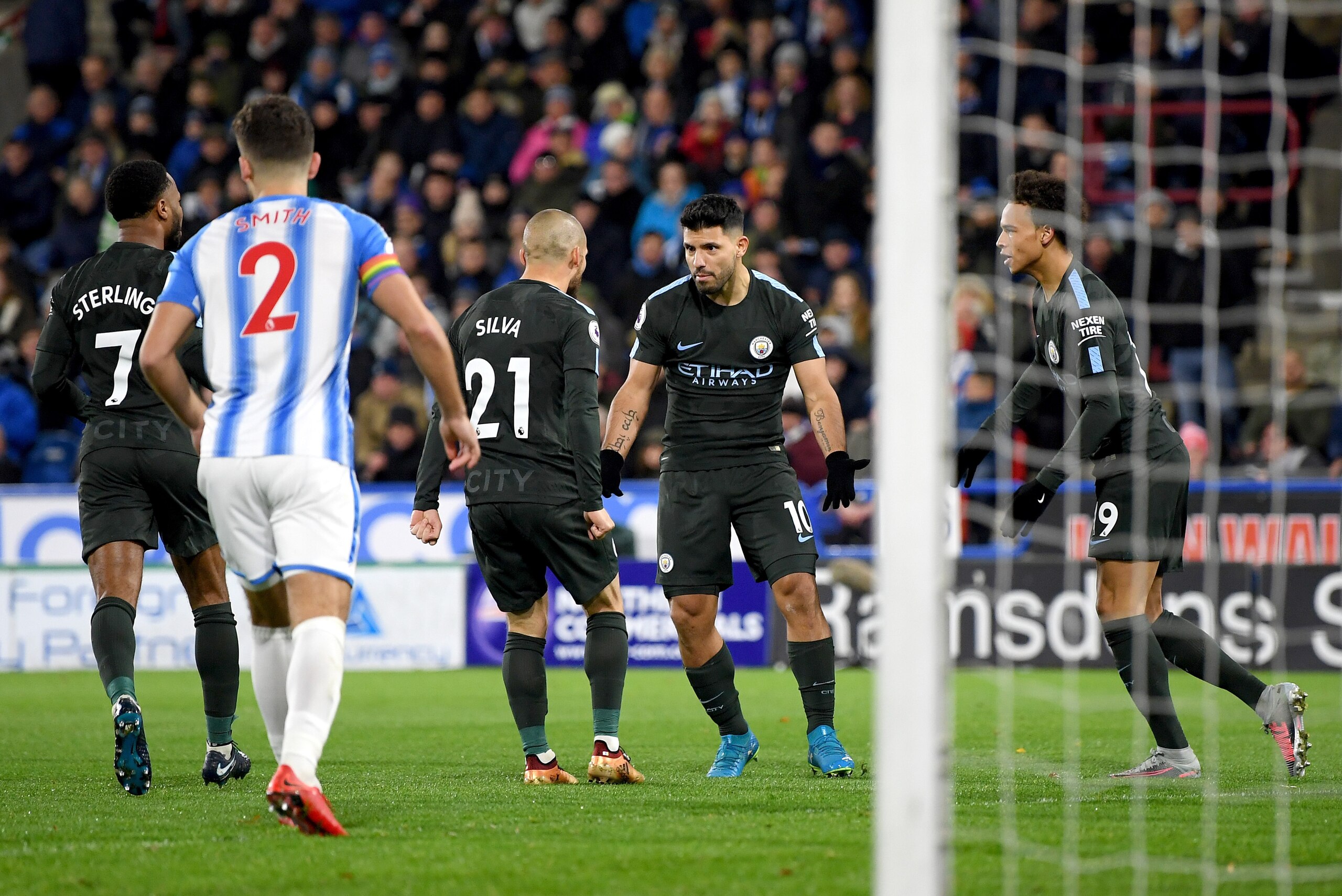 HUDDERSFIELD, ENGLAND - NOVEMBER 26:  Sergio Aguero of Manchester City celebrates scoring the first Manchester City goal with David Silva, Leroy Sane and Raheem Sterling during the Premier League match between Huddersfield Town and Manchester City at John