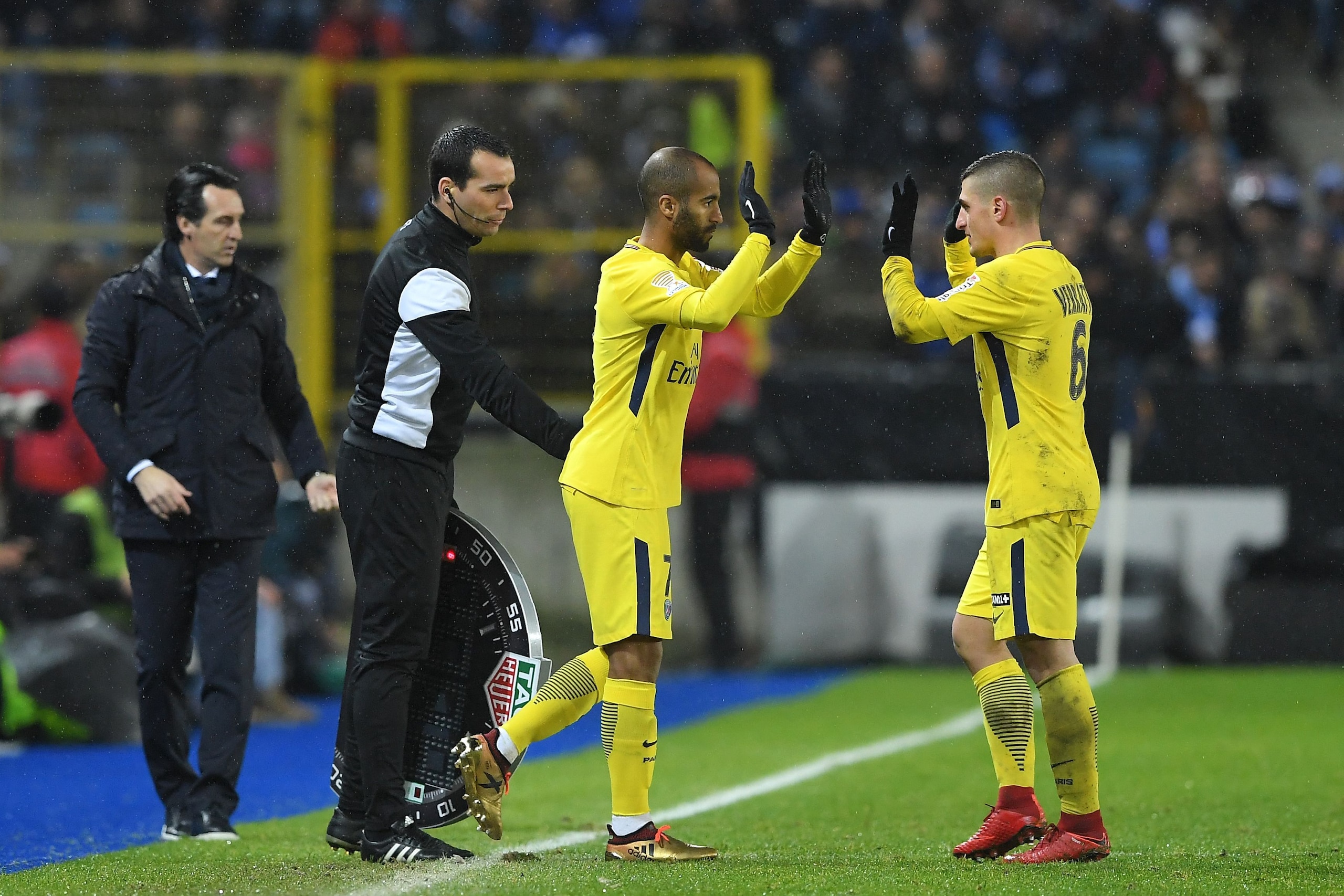 Paris Saint-Germain's Brazilian forward Lucas (2nd-R) leaves the pitch to replace Paris Saint-Germain's Italian midfielder Marco Verratti (1st-R) next to their Paris Saint-Germain's Spanish head coach Unai Emery (1st-L) during the French League Cup round 