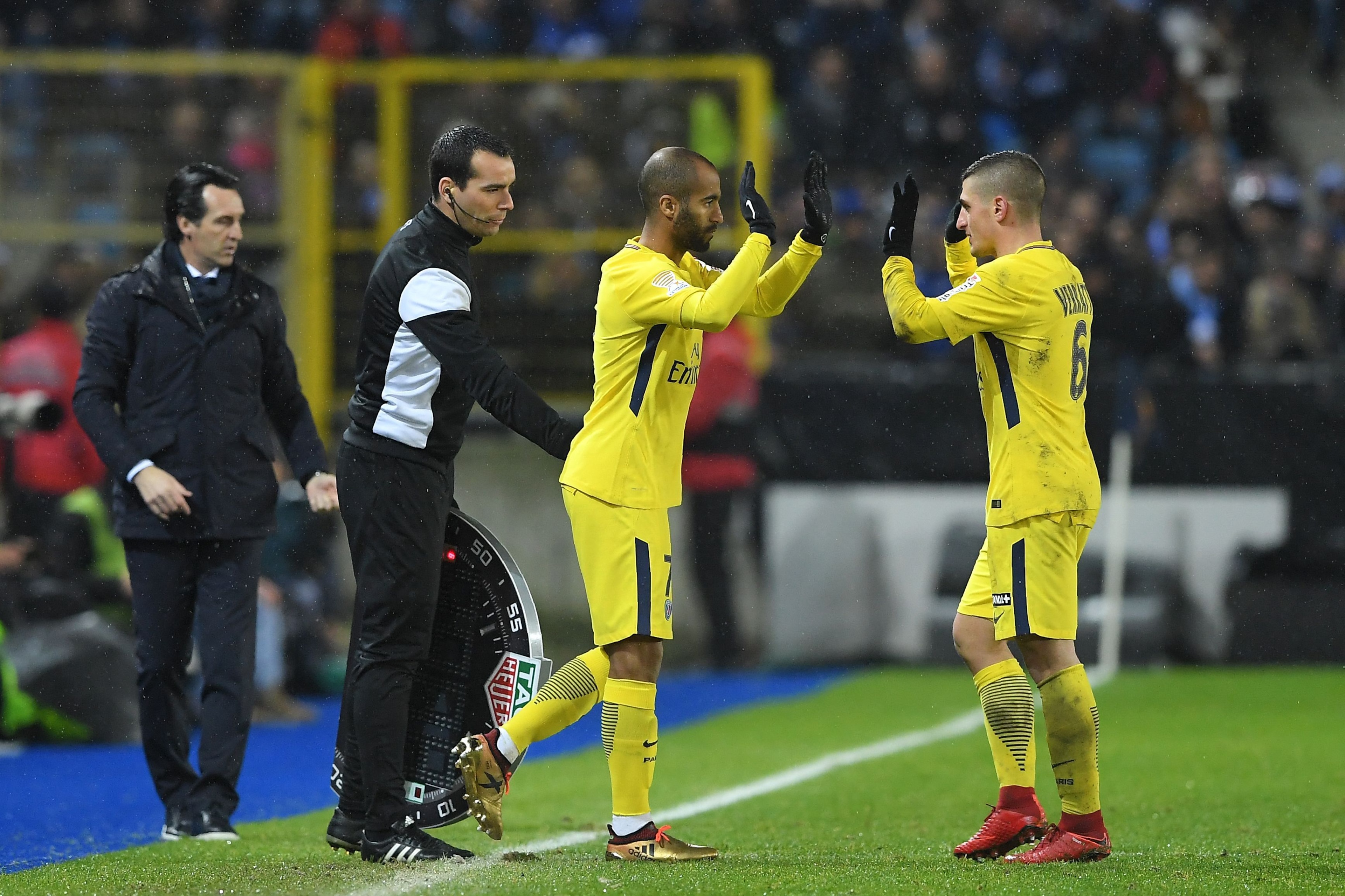 Paris Saint-Germain's Brazilian forward Lucas (2nd-R) leaves the pitch to replace Paris Saint-Germain's Italian midfielder Marco Verratti (1st-R) next to their Paris Saint-Germain's Spanish head coach Unai Emery (1st-L) during the French League Cup round 