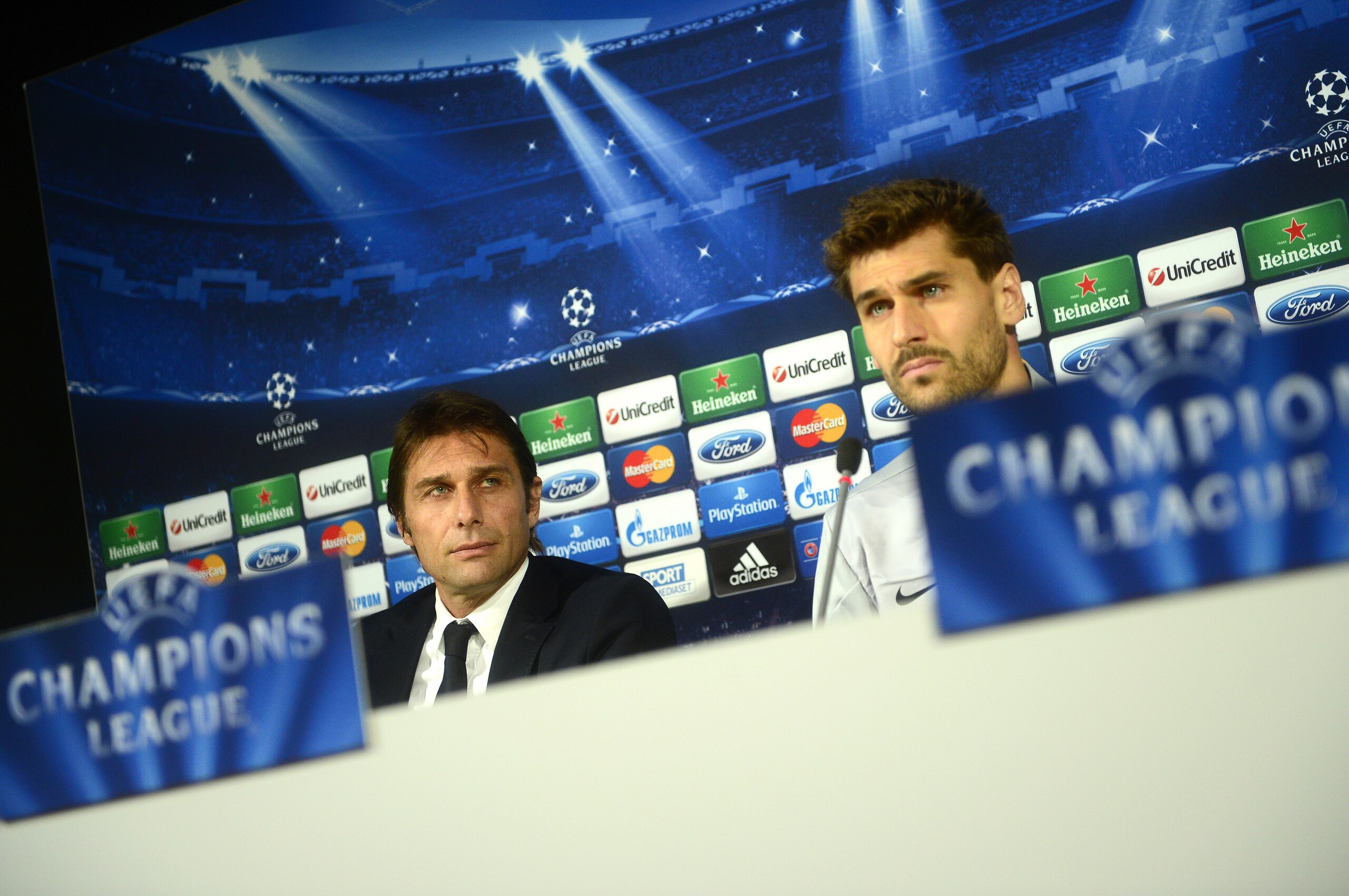 Juventus' Spanish foward Fernando Torres Llorente (R) and Juventus' coach Antonio Conte answer journalists during a press conference on the eve of the UEFA Champions League group B football match Juventus vs Copenhagen, on November 26, 2013 at their train